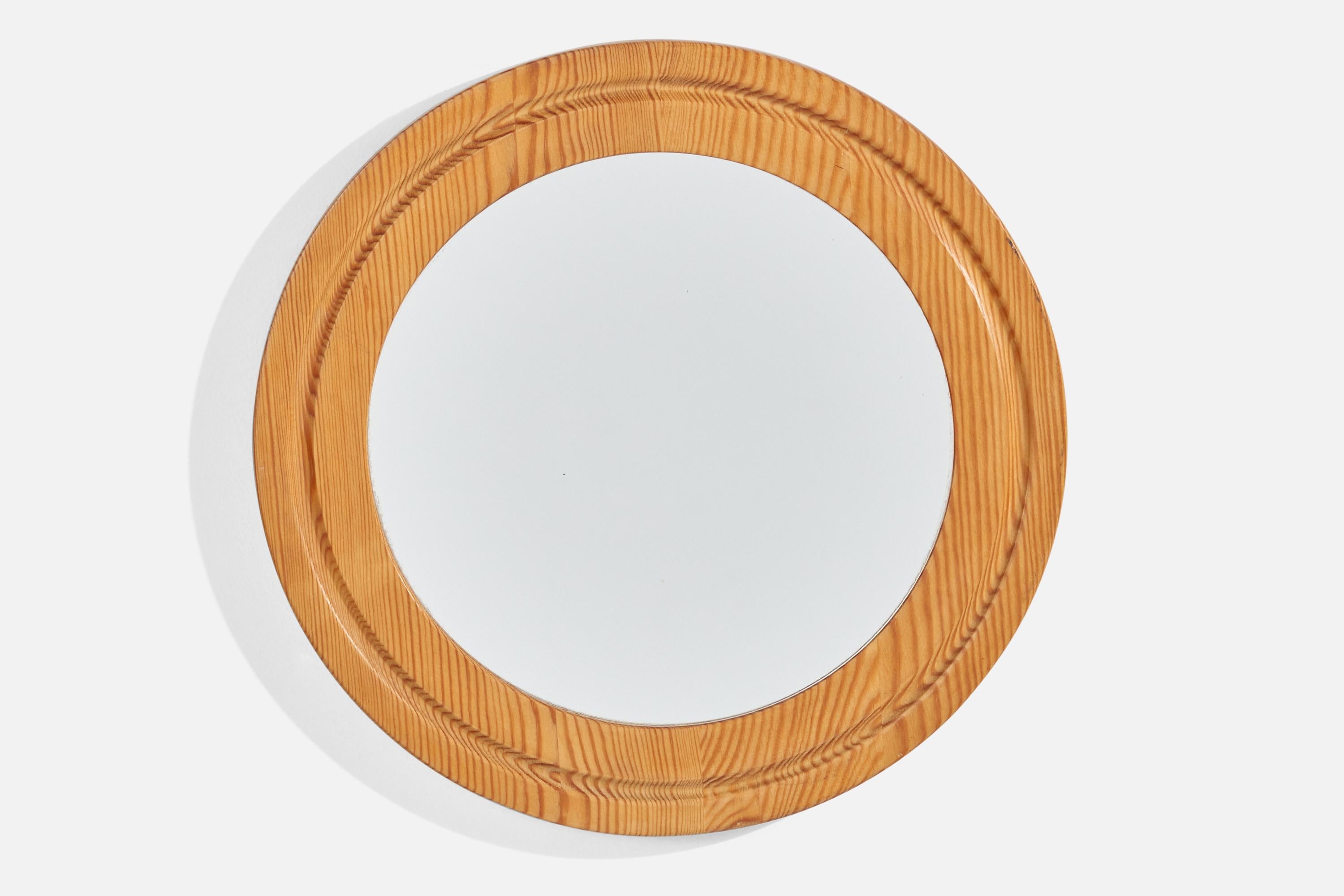 A pine wall mirror designed and produced in Sweden, 1970s.
  