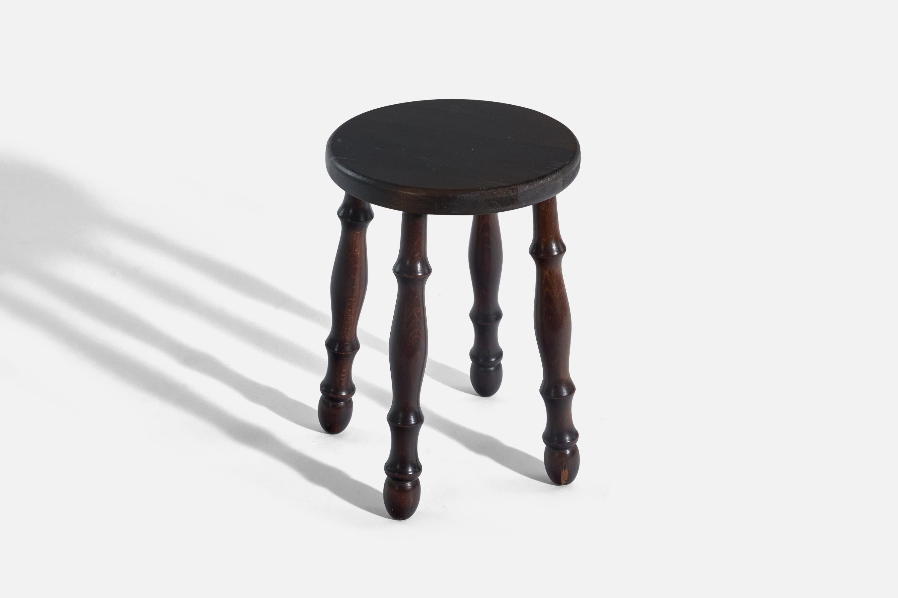 A dark-stained pine stool designed and produced in Sweden, c. 1970s.