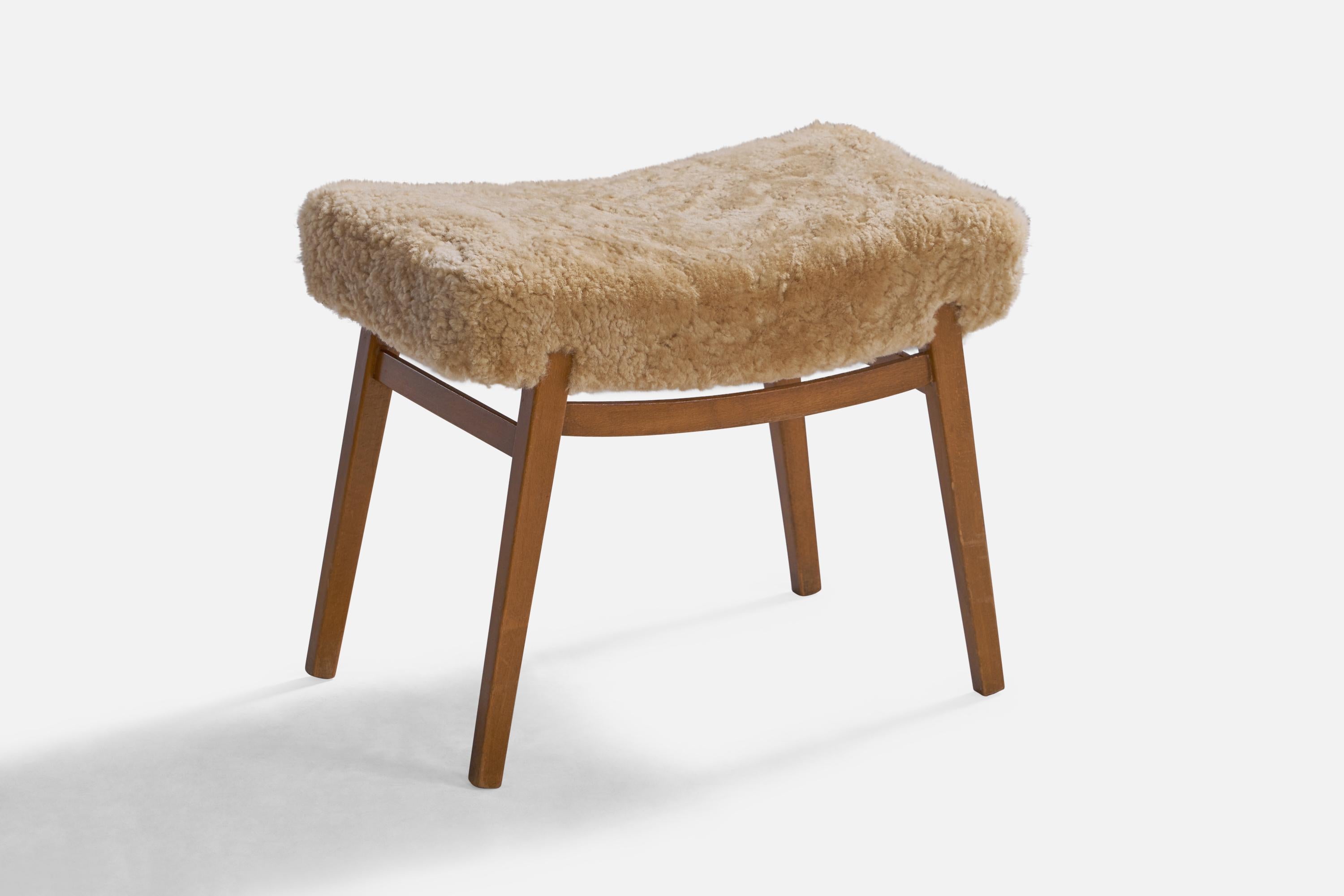 An oak and shearling stool designed and produced in Sweden, 1950s.

Seat height: 17.5”
