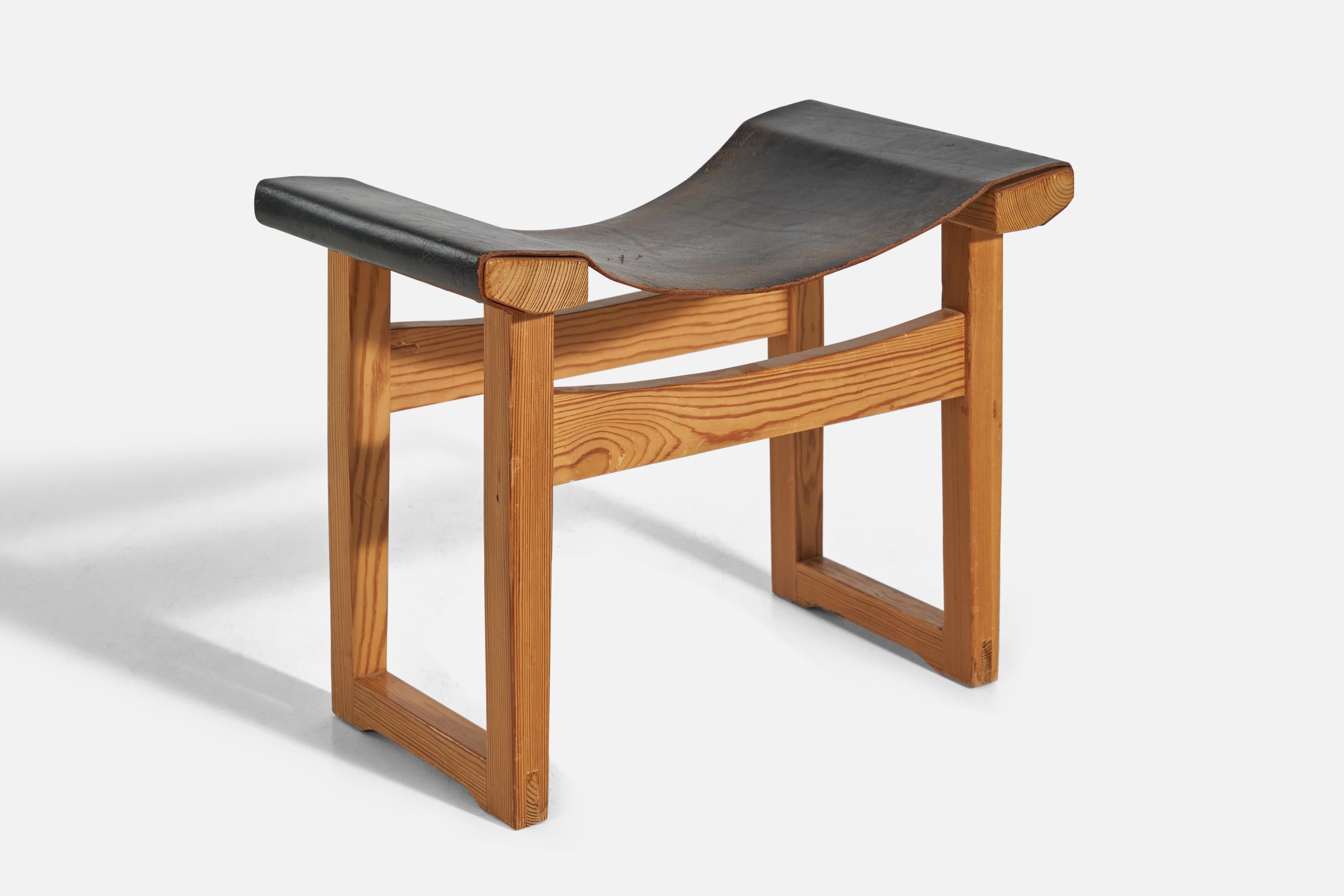 A pine and black-dyed leather stool designed and produced in Sweden, 1960s.