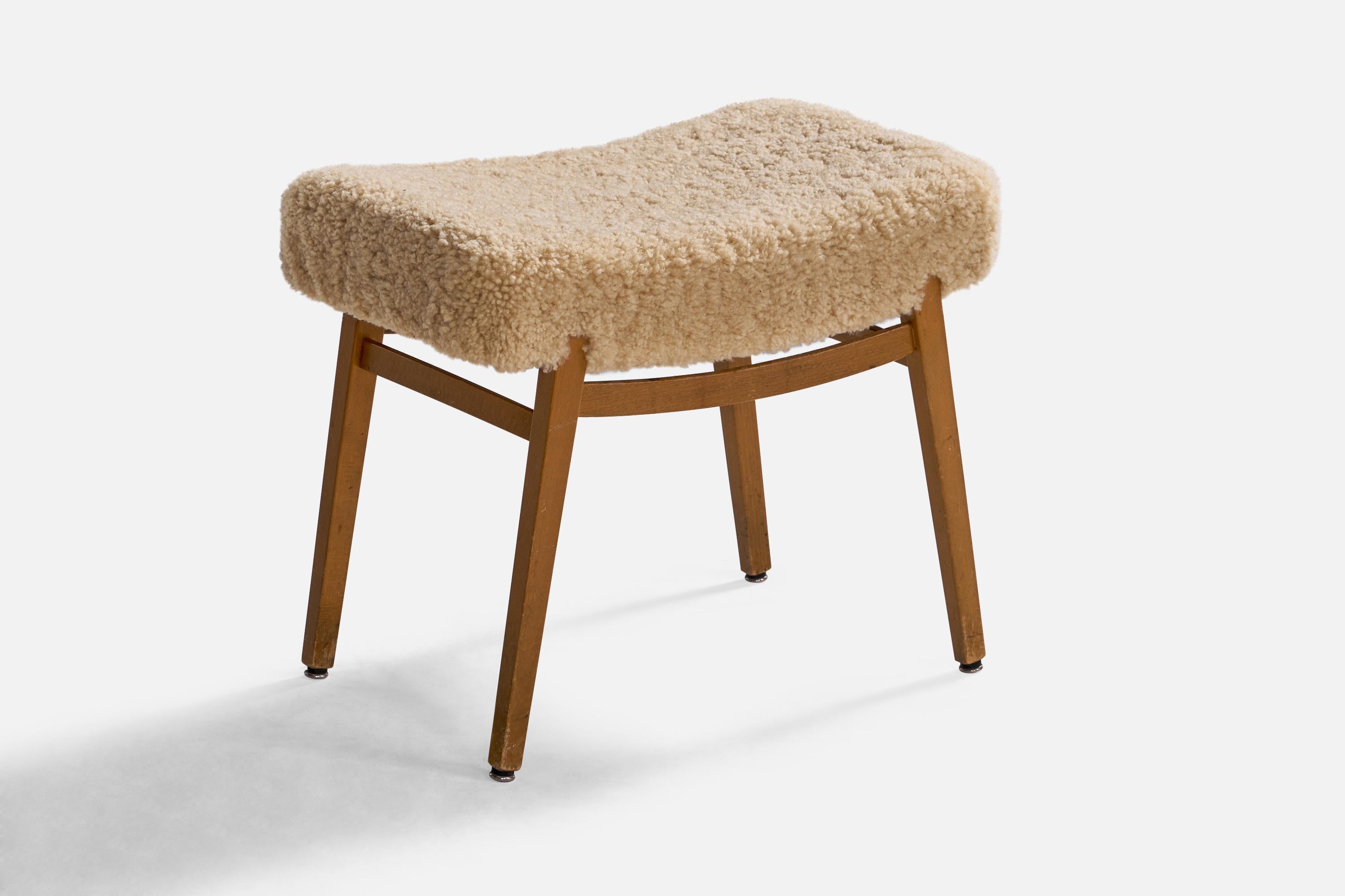 A beige shearling and oak stool designed and produced in Sweden, 1950s.

seat height: 18.25

