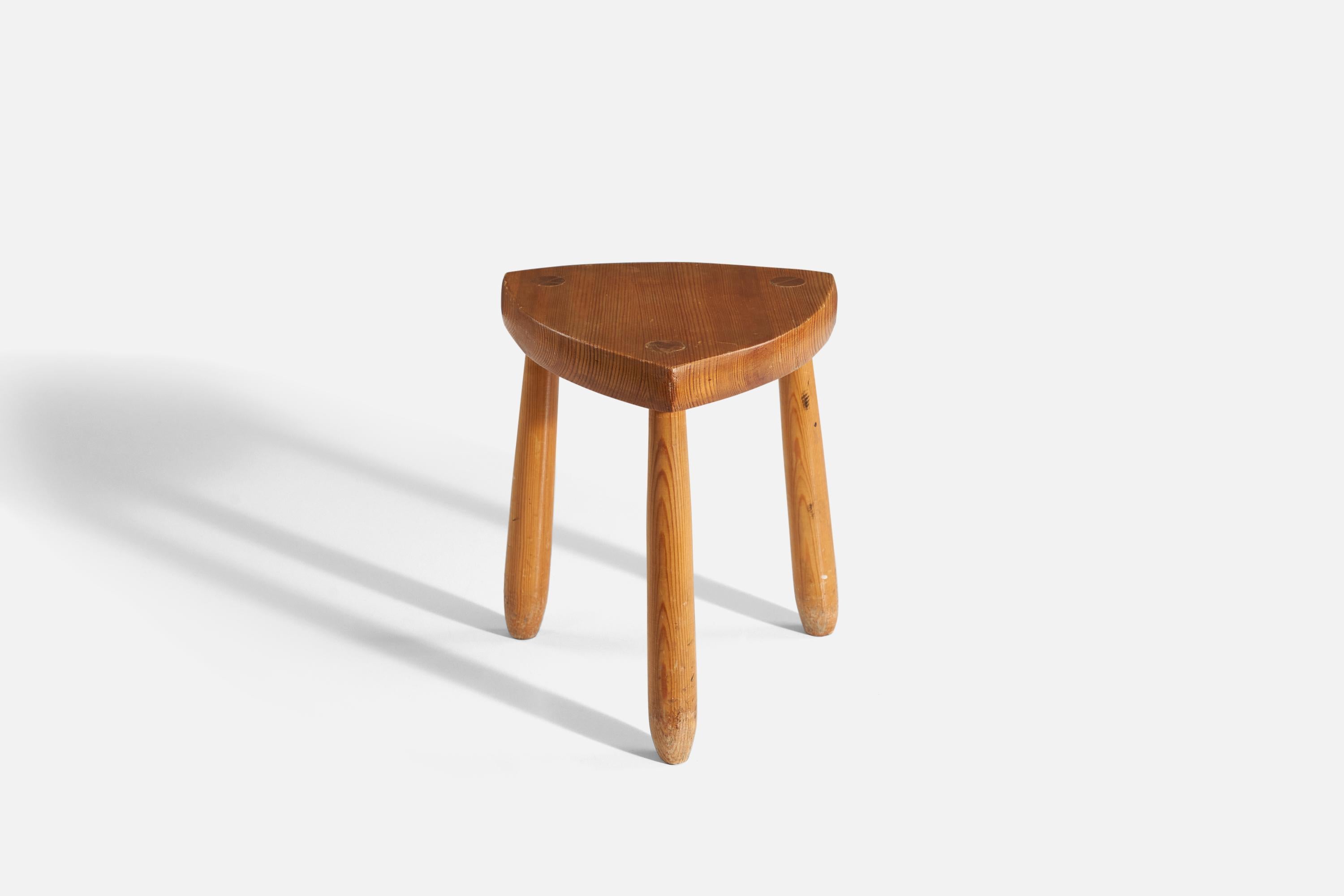 A solid pine wood stool produced in Sweden. Signed 