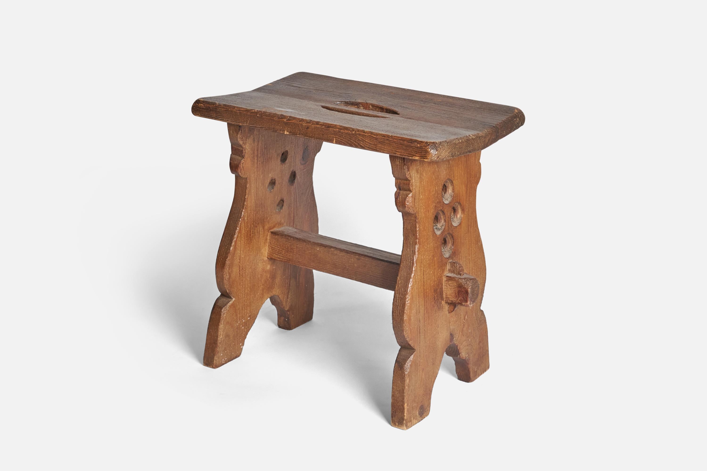 A stained pine stool designed and produced in Sweden, circa 1940s.