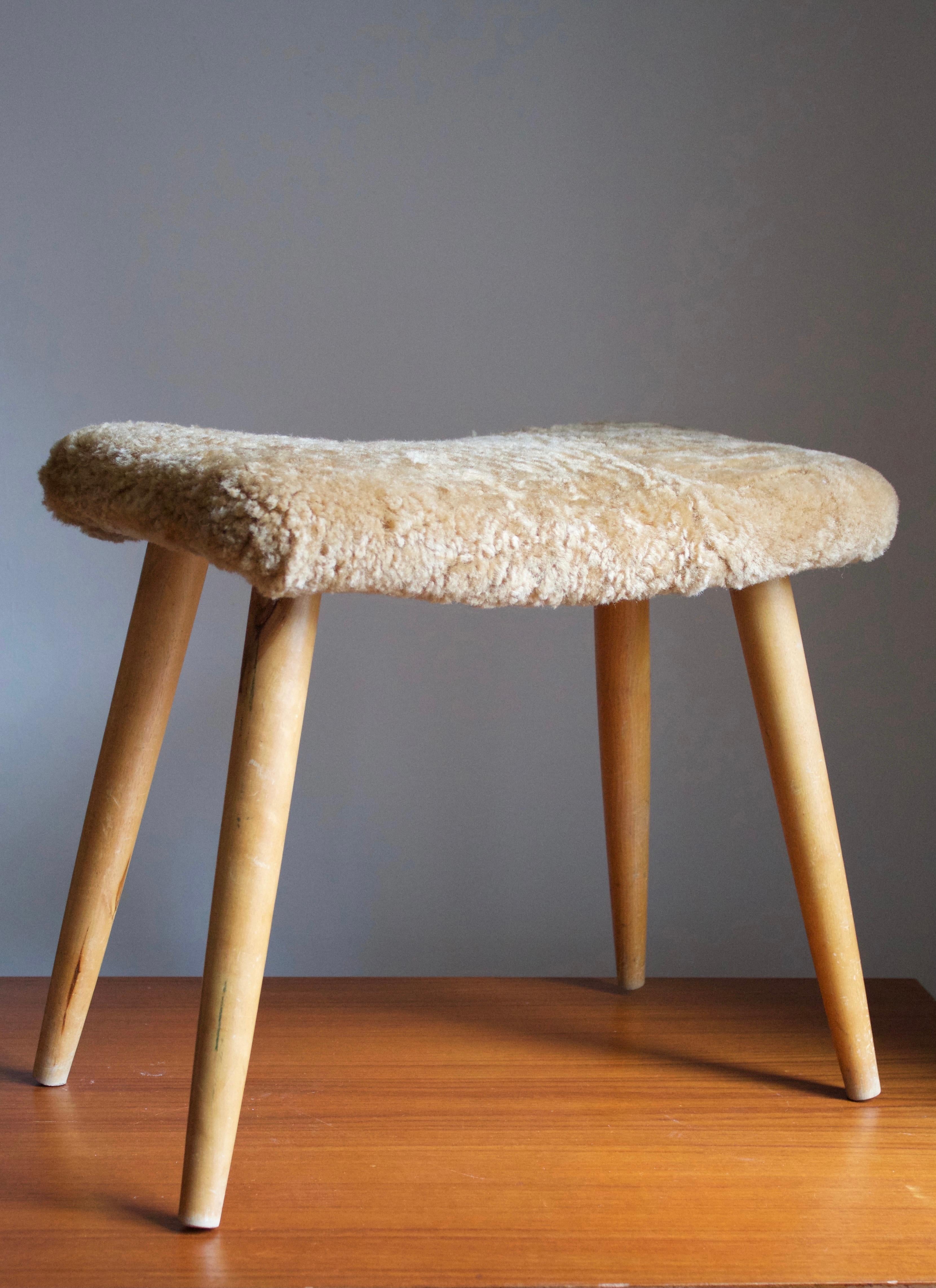 A stool in stained oak, overstuffed seat reupholstered in brand new sheepskin upholstery. Produced in Sweden, 1950s.

Other designers of the period include Finn Juhl, Hans Wegner, Isamu Noguchi, Charlotte Perriand, and.