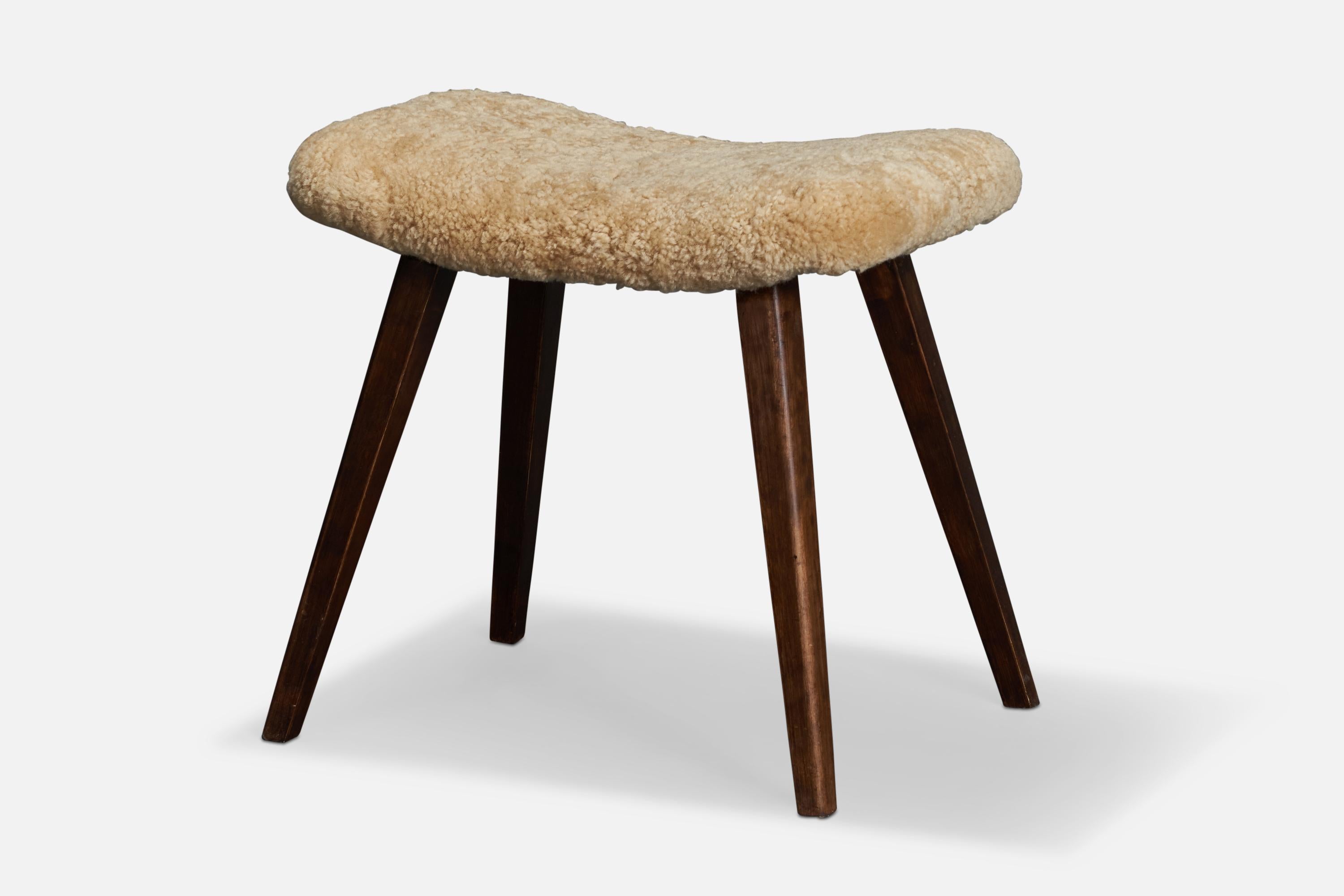 A dark-stained wood and beige shearling stool designed and produced in Sweden, 1950s.

Seat height: 19.7”