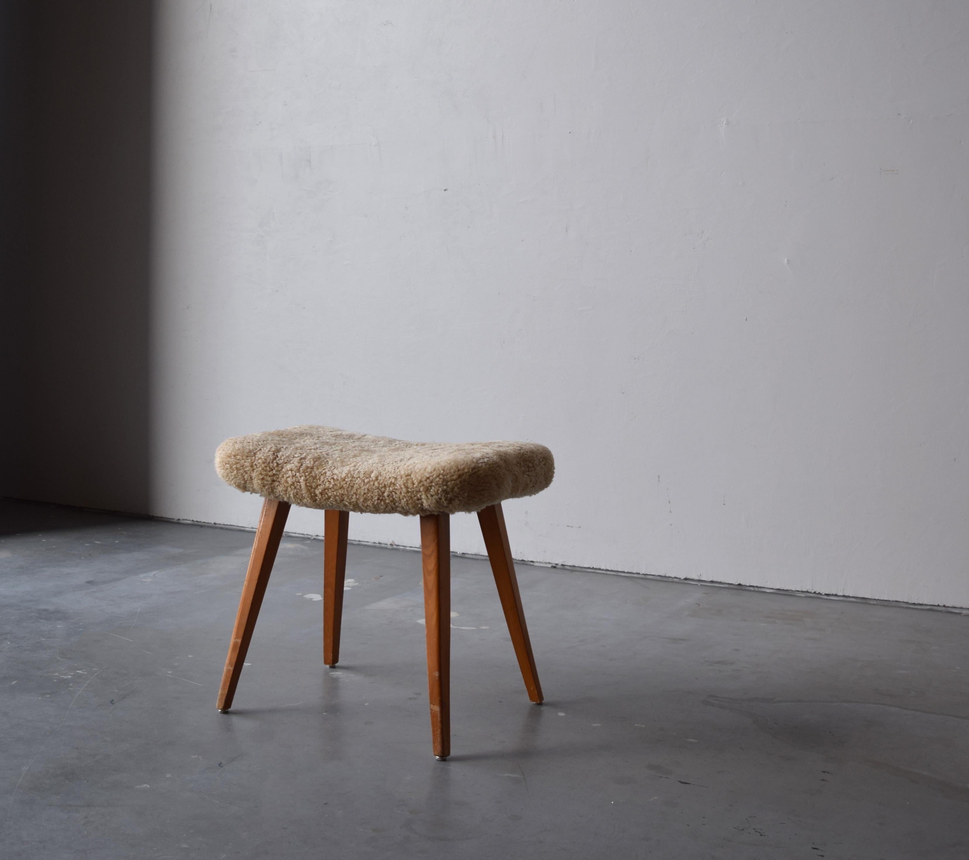 A stool in stained wood, overstuffed seat reupholstered in brand new sheepskin upholstery. Produced in Sweden, 1950s.

Other designers of the period include Finn Juhl, Hans Wegner, Isamu Noguchi, Charlotte Perriand.