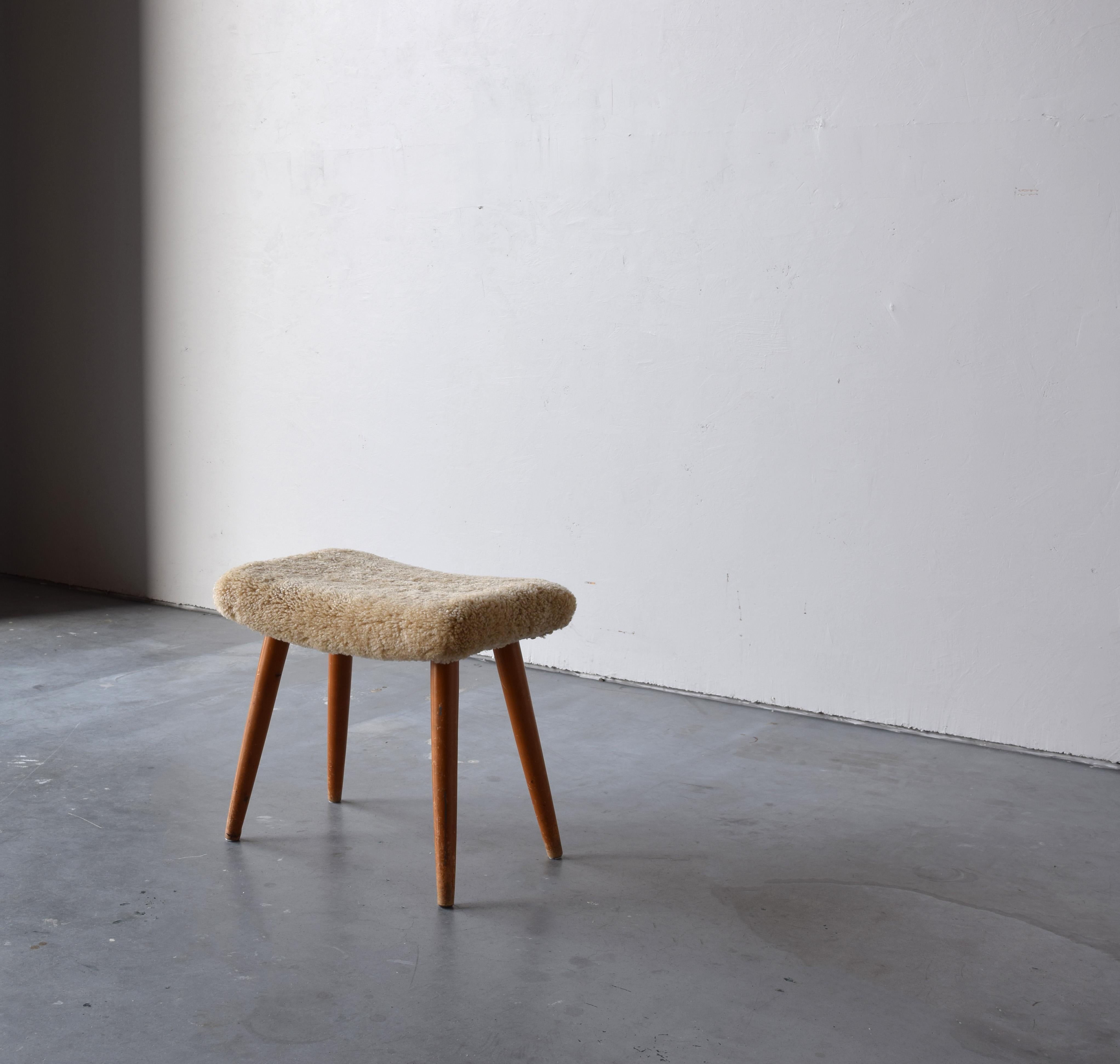 A stool in stained wood, overstuffed seat reupholstered in brand new sheepskin upholstery. Produced in Sweden, 1950s.

Other designers of the period include Finn Juhl, Hans Wegner, Isamu Noguchi, Charlotte Perriand.