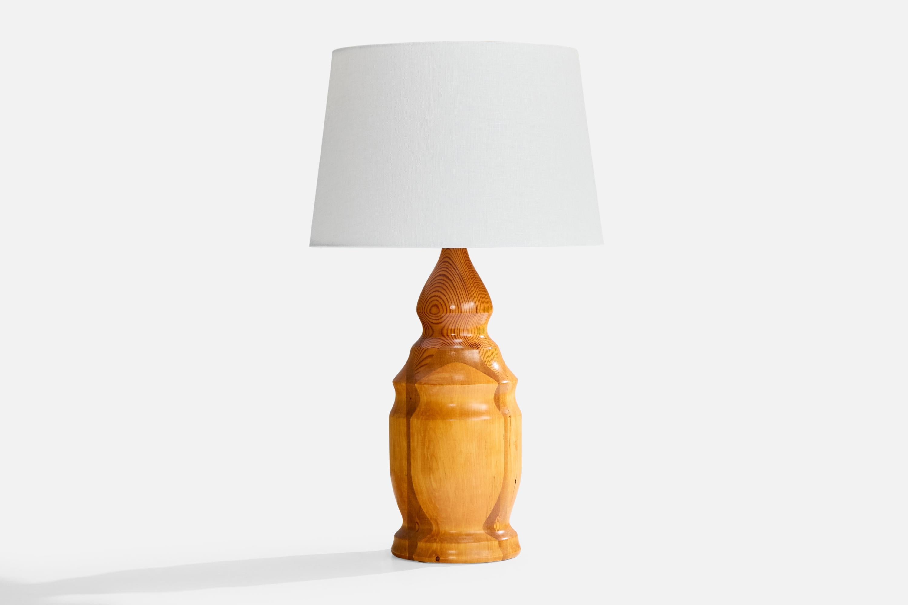 A stack-laminated birch, mahogany and pine table lamp designed and produced in Sweden, initialed and dated 1985.

Dimensions of Shade (inches): 10” Top Diameter x 12” Bottom Diameter x 8” Height

Dimensions of Lamp with Shade (inches): 20.75” Height