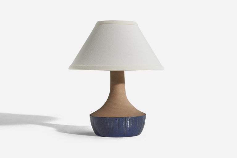 A blue and brown stoneware table lamp designed and produced in Sweden, c. 1960s.

Sold without lampshade. 
Dimensions of Lamp (inches) : 10.37 x 6.37 x 6.37 (H x W x D)
Dimensions of Shade (inches) : 4.25 x 10.25 x 6 (T x B x S)
Dimension of