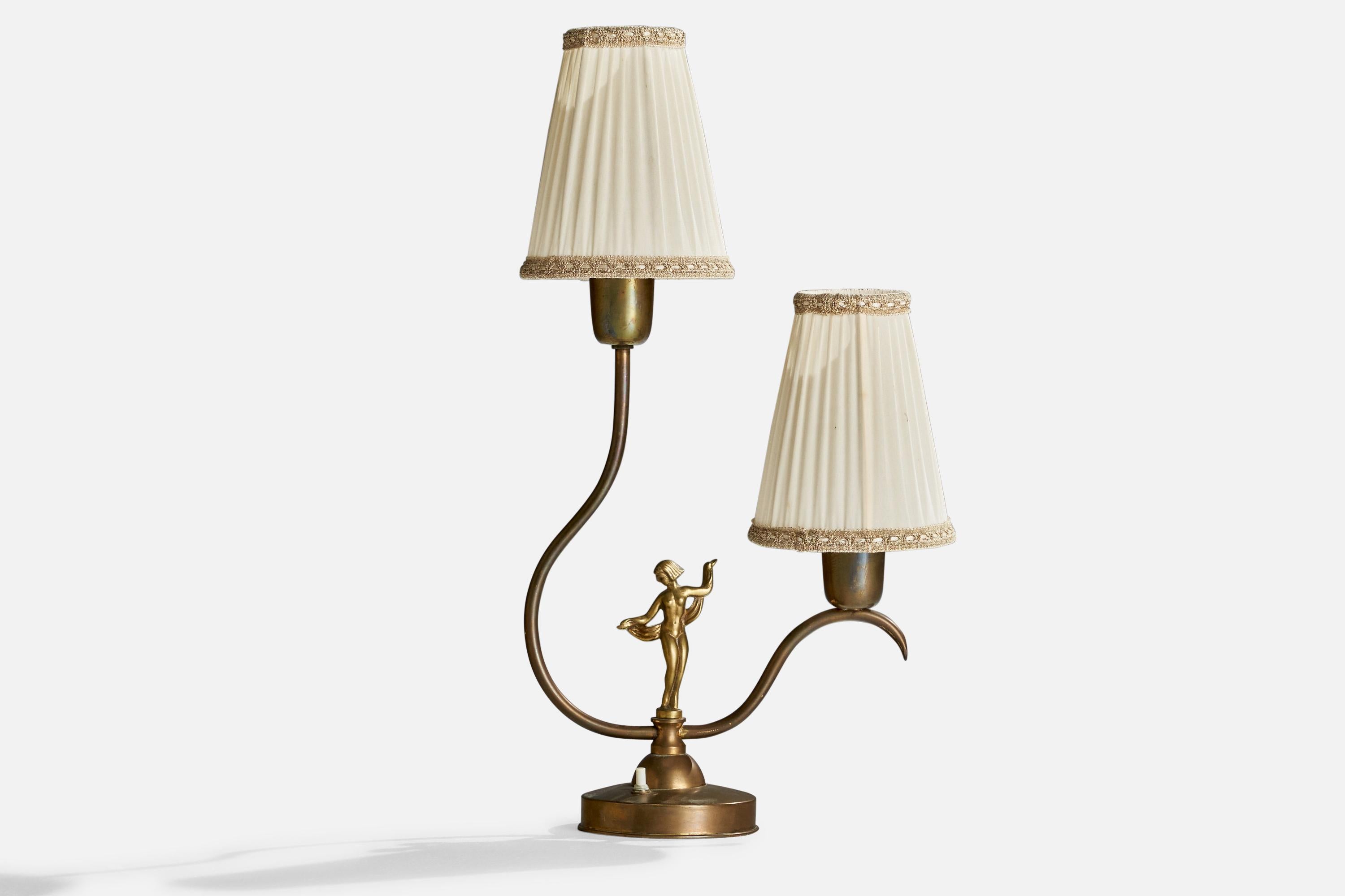 A brass and off-white fabric table lamp designed and produced in Sweden, c. 1930s.

Overall Dimensions (inches): 20.25” H x 11” W x 5.25” D
Stated dimensions include shades
Bulb Specifications: E-26 Bulb
Number of Sockets: 2
All lighting will be