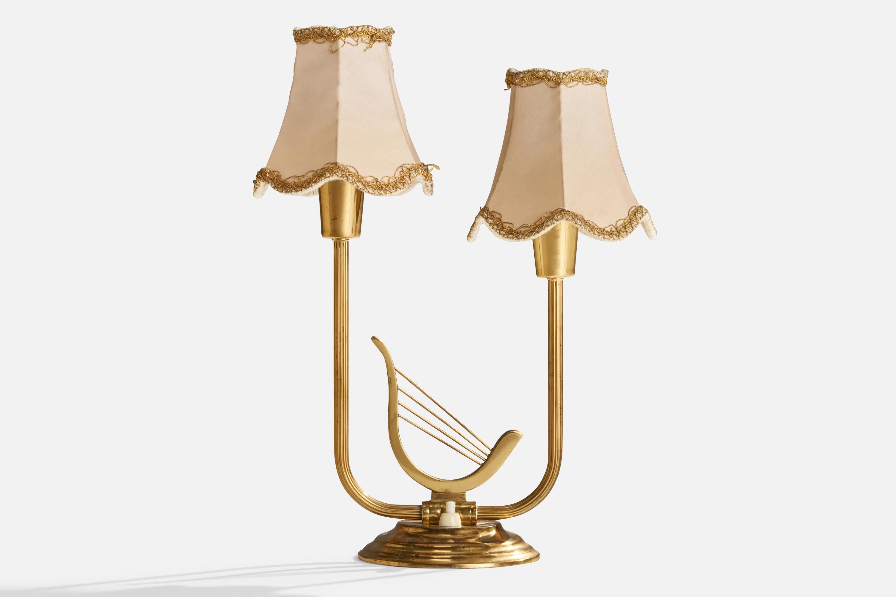 A brass and fabric table lamp designed and produced in Sweden, c. 1940s.

Overall Dimensions (inches): 14” H x 10.5” W x 4.75” D
Stated dimensions include shade.
Bulb Specifications: E-14 Bulb
Number of Sockets: 2
All lighting will be converted for