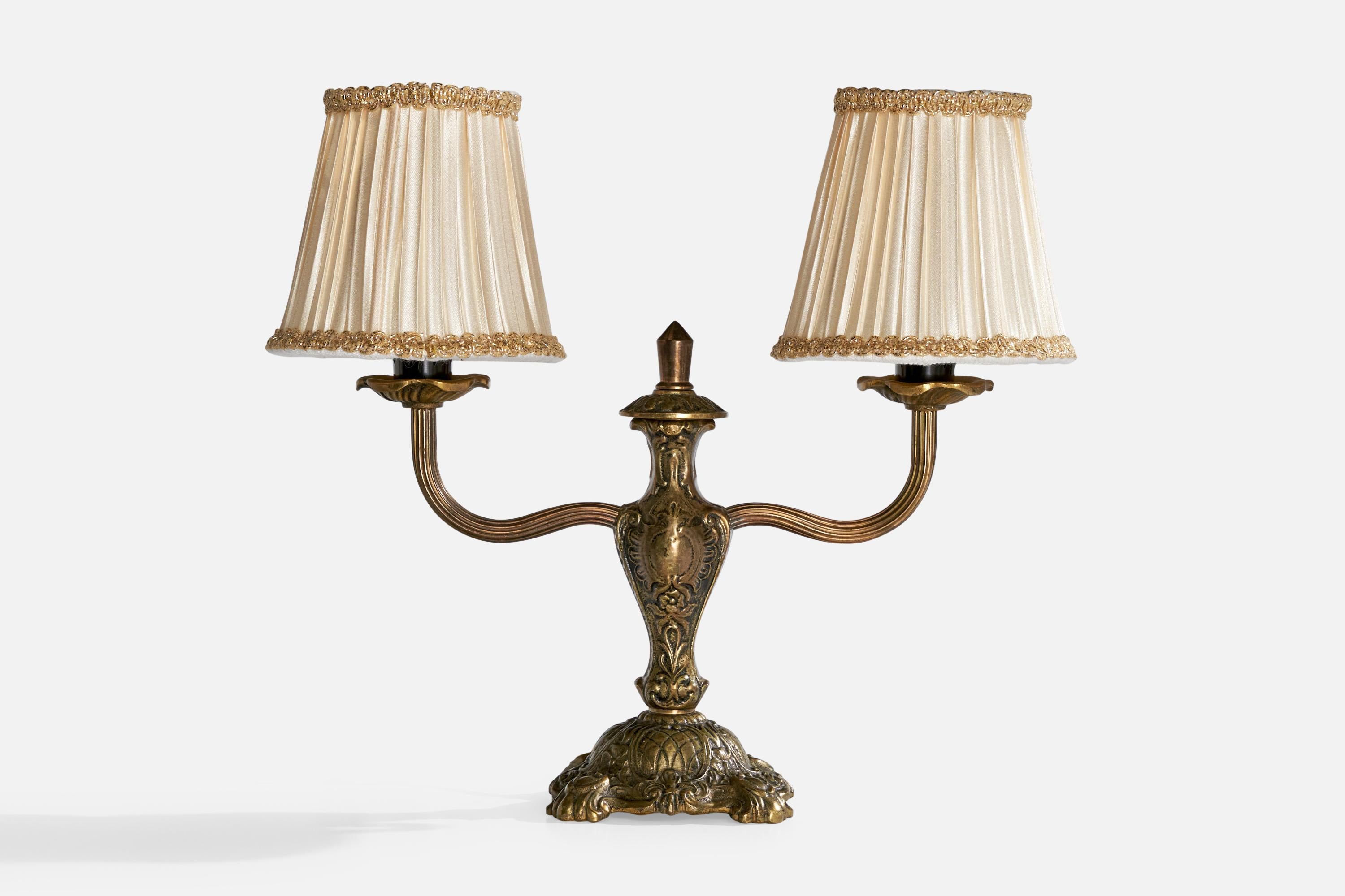 A brass and off-white table lamp designed and produced in Sweden, c. 1950s.

Dimensions of Lamp with Shade (inches):  10.75” H x  12.5” W x  4.625“ D

Bulb Specifications: E-12

Number of Sockets (per fixture): 2

Sold with lampshades.

All lighting