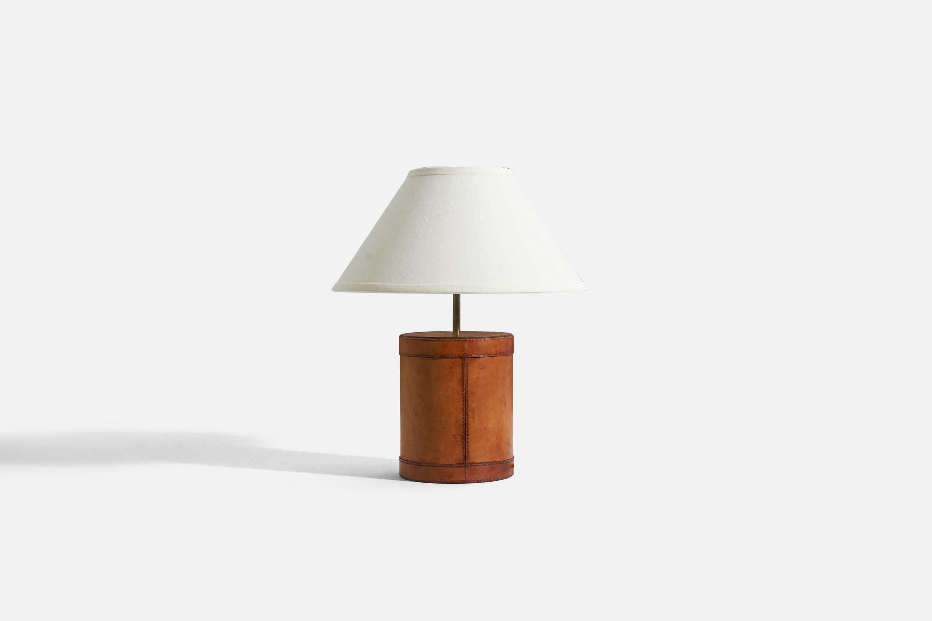 A brass and leather table lamp designed and produced by a Swedish designer, Sweden, 1960s.

Sold without lampshade. 
Dimensions of lamp (inches) : 14.375 x 6.5 x 6.5 (H x W x D)
Dimensions shade (inches) : 5.75 x 14 x 8 (T x B x H)
Dimension of