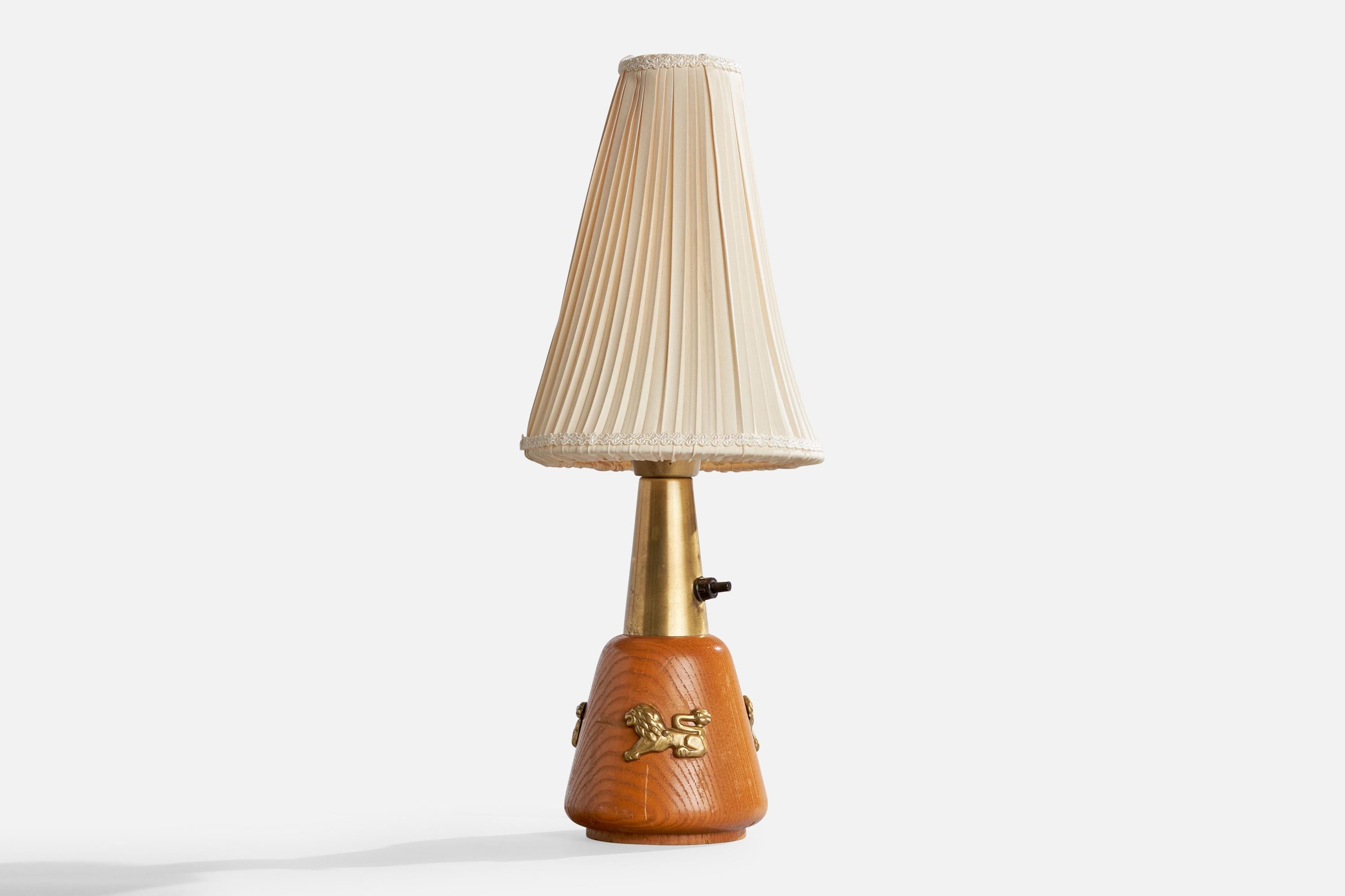A brass, oak and off-white fabric table lamp designed and produced in Sweden, c. 1940s.

Dimensions of Lamp with Shade (inches): 16.5“ H x 6.4“ Diameter

Bulb Specifications: E-26 globe

Number of Sockets (per fixture): 1

Sold with lampshade.

All
