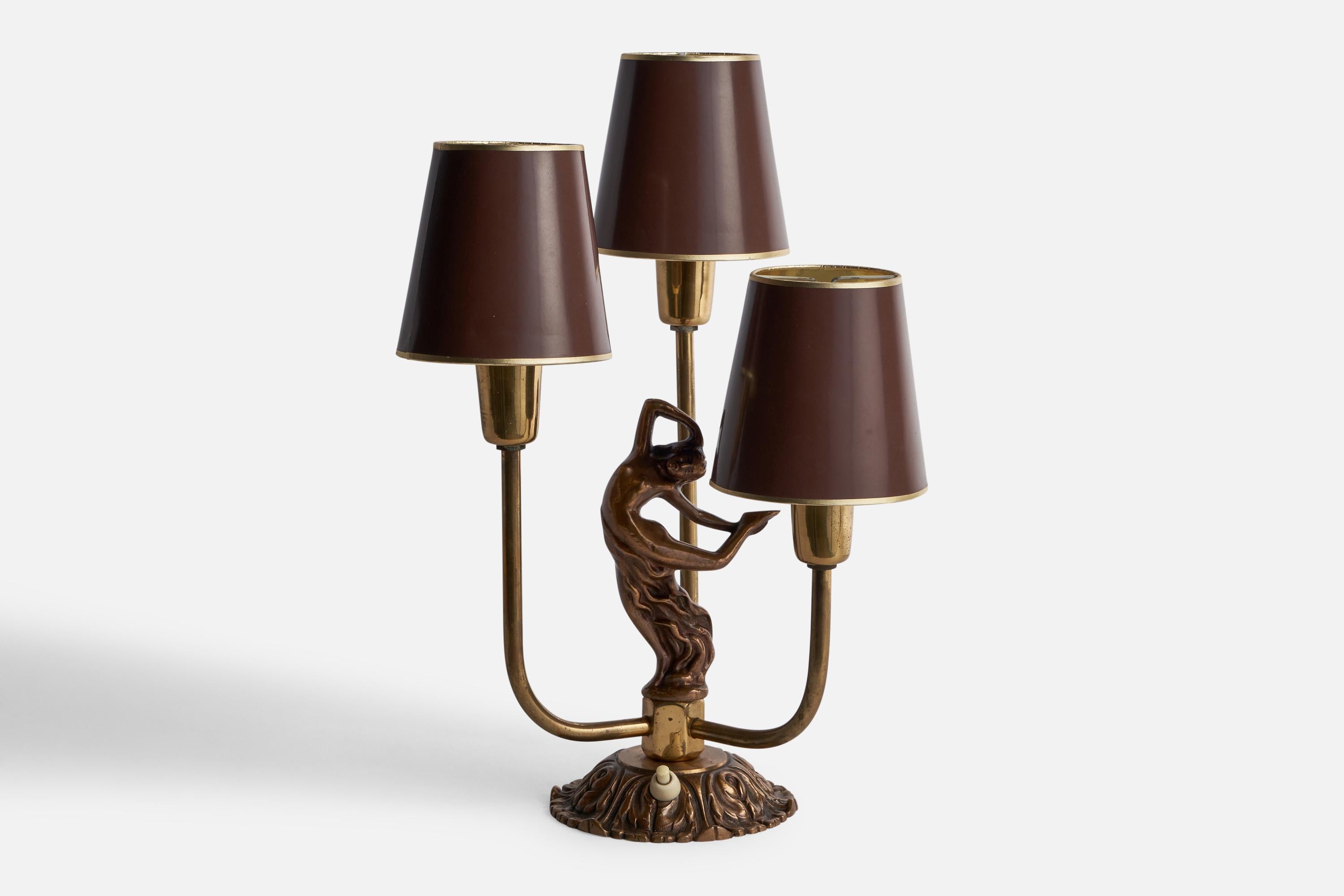 A three-armed brass and brown-lacquered paper table lamp designed and produced in Sweden, 1930s.

Overall Dimensions (inches): 14.5” H x 10.5” W x 9” D
Bulb Specifications: E-14 Bulbs
Number of Sockets: 3
All lighting will be converted for US usage.