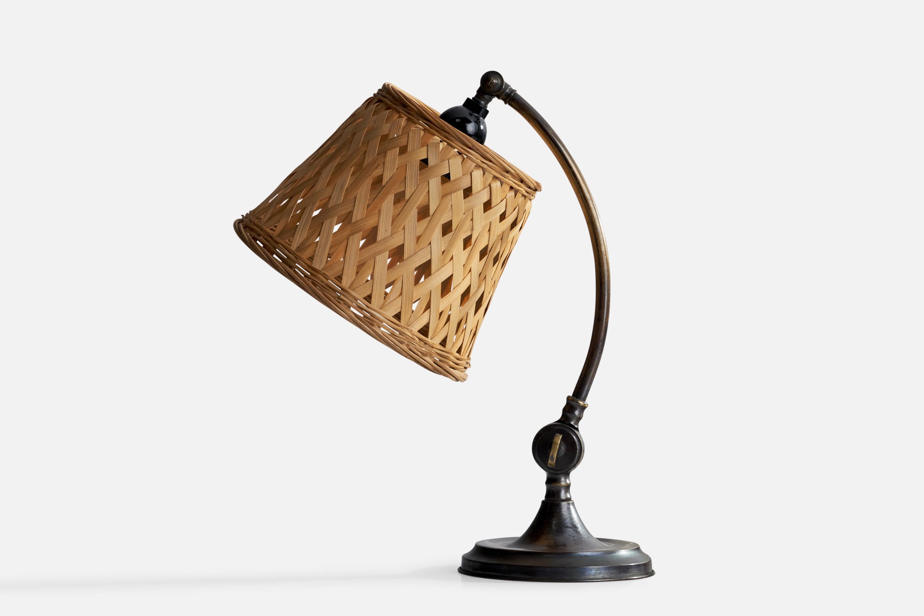 An adjustable brass and rattan table lamp designed and produced in Sweden, 1930s.

Overall Dimensions (inches): 15” H x 8” W x 12.5” D
Stated dimensions include shade.
Bulb Specifications: E-26 Bulb
Number of Sockets: 1
All lighting will be