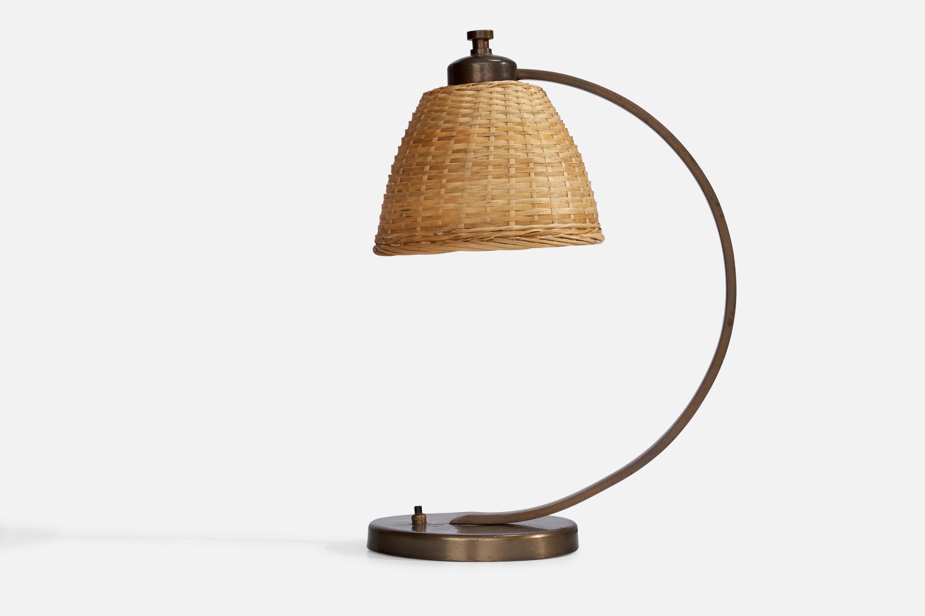 A brass and rattan table lamp designed and produced in Sweden, 1930s.

Overall Dimensions (inches): 16” H x 7”  W x 11.75” D
Stated dimensions include shade.
Bulb Specifications: E-26 Bulb
Number of Sockets: 1
All lighting will be converted for US