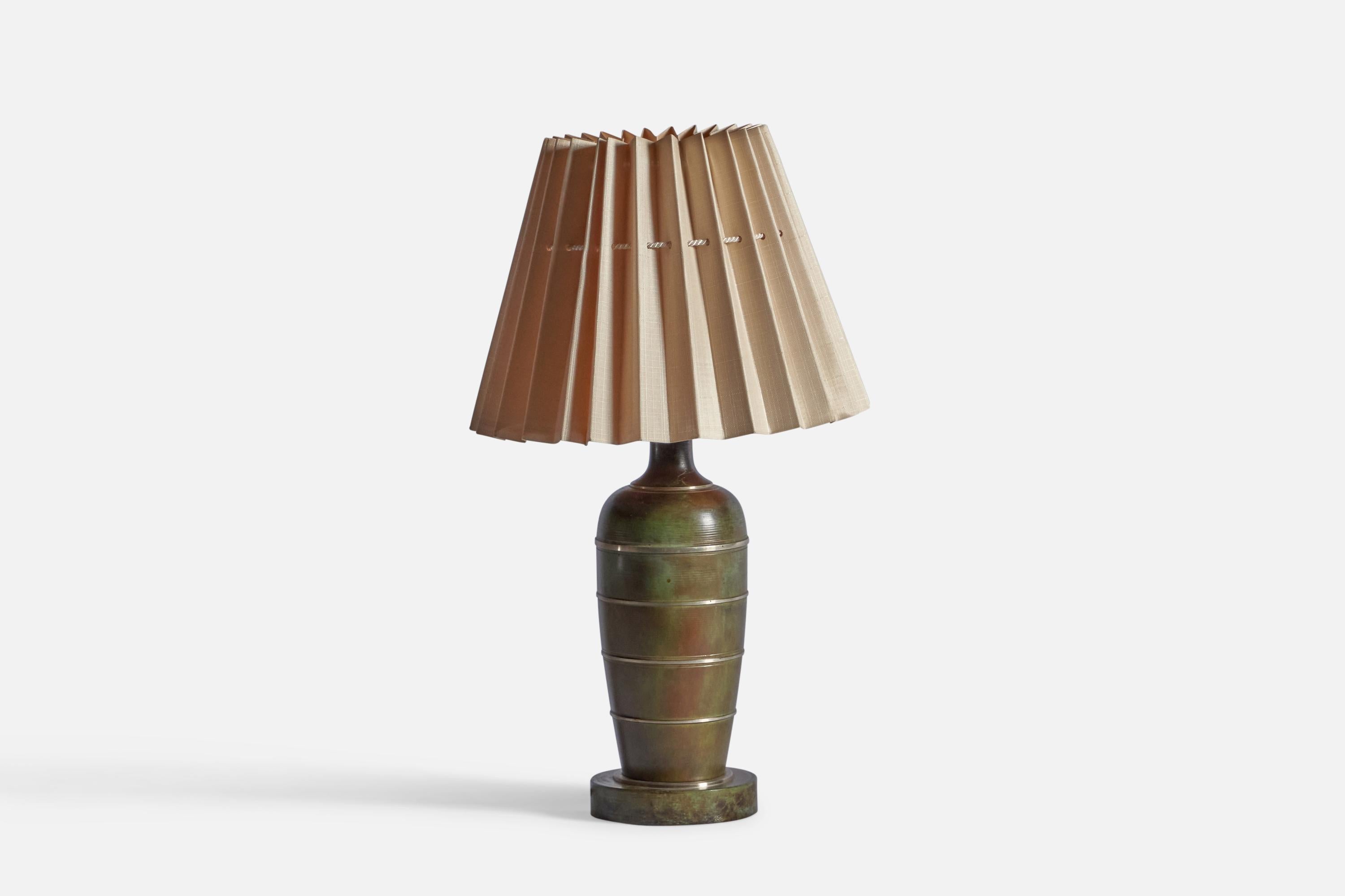 A bronze and paper table lamp, designed and produced in Sweden, 1930s.

Sold with Lampshade

Dimensions stated are of Table Lamp with Lampshade attached.