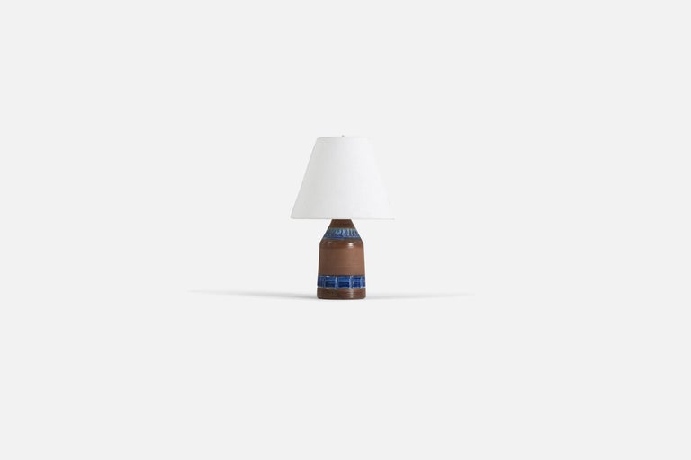 A blue and brown-glazed stoneware table lamp, designed and produced in Sweden, 1960s.

Sold without lampshade. 

Measurements listed are of lamp.
Shade : 4 x 8 x 6.75
Lamp with shade : 12.75 x 8 x 8.
