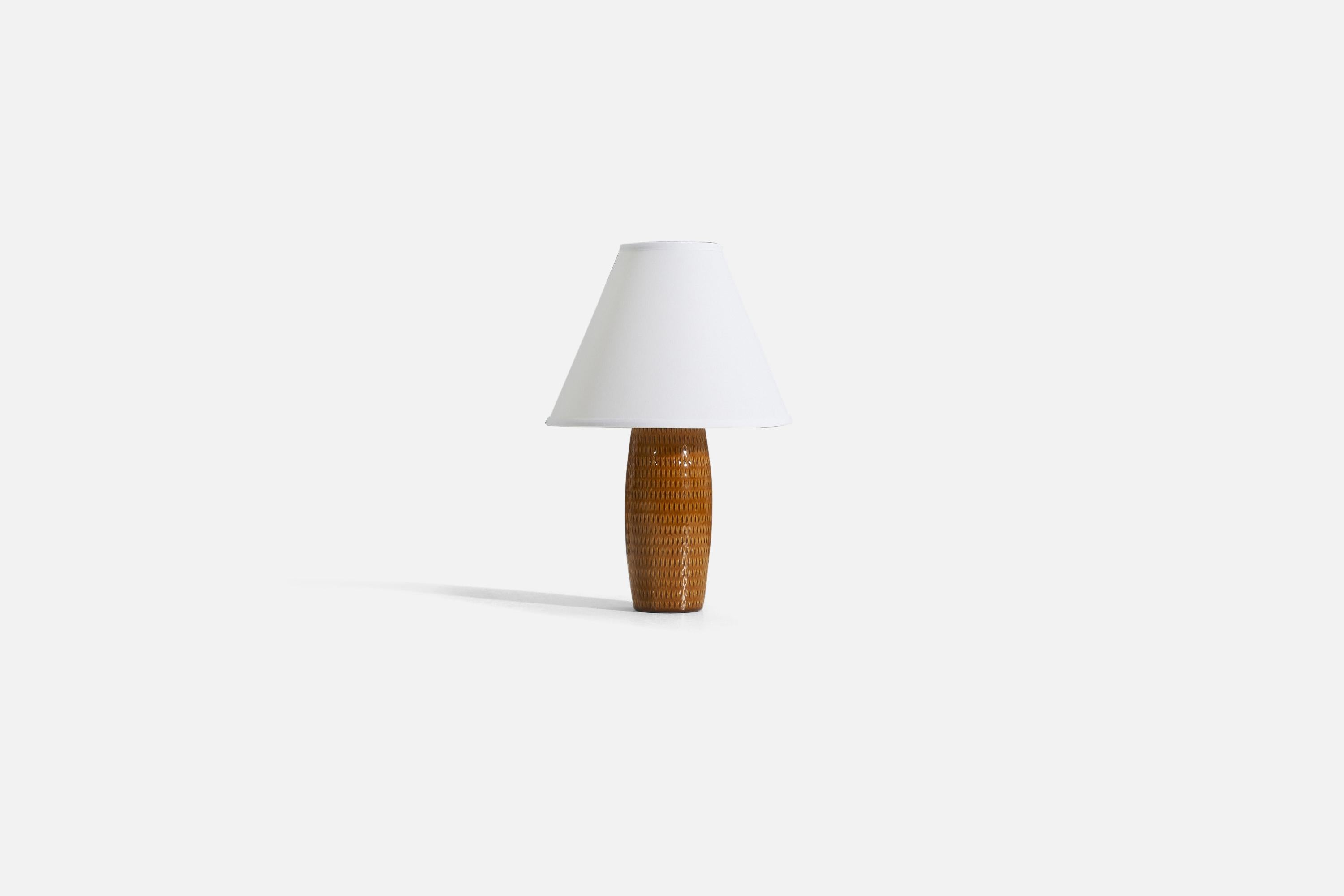 A brown-glazed earthenware table lamp produced in Sweden, c. 1950s.

Sold without lampshade. 
Dimensions of Lamp (inches) : 11 x 4 x 4 (H x W x D)
Dimensions Shade (inches) : 4 x 10 x 8 (T x B x H)
Dimension of Lamp with shade (inches) : 15 x