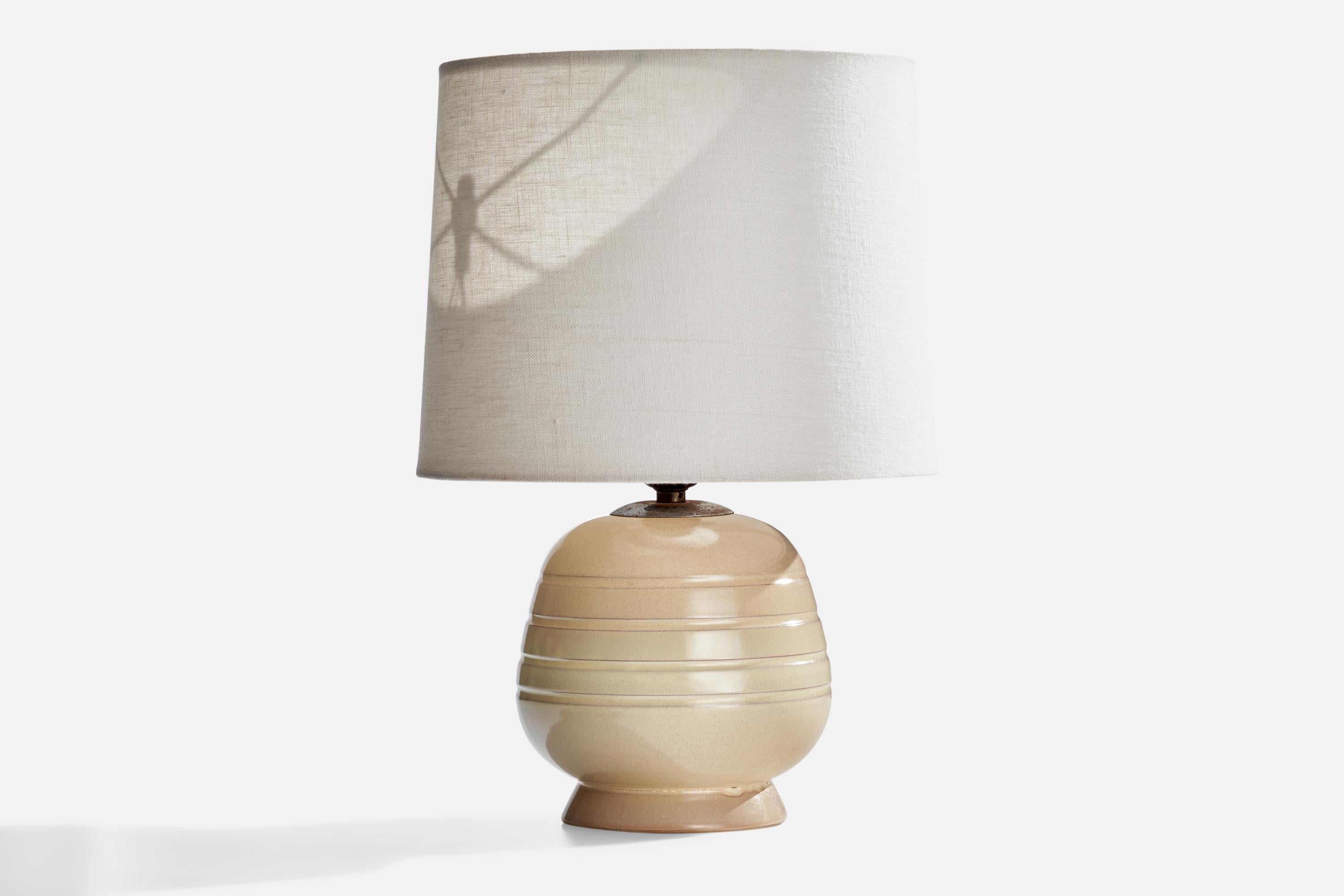 A cream beige table lamp designed and produced in Sweden, c. 1930s.

Dimensions of Lamp (inches): 9.25” H x 6” Diameter
Dimensions of Shade (inches): 5” Top Diameter x 8” Bottom Diameter x 6” H
Dimensions of Lamp with Shade (inches): 12.5” H x 8”