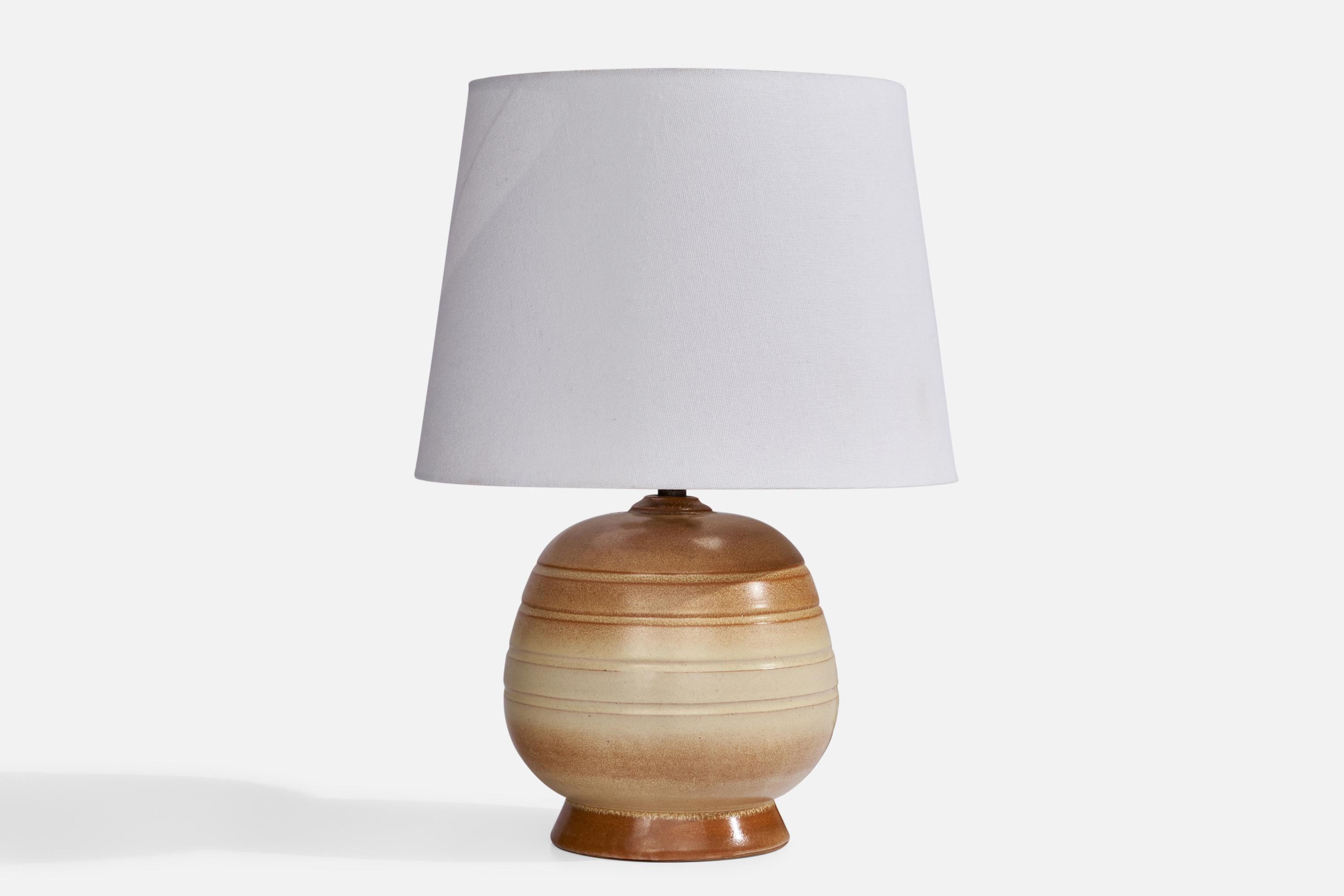 A brown and beige-glazed ceramic table lamp designed and produced in Sweden, c. 1940s.

Dimensions of Lamp (inches): 9” H x 6” Diameter
Dimensions of Shade (inches): 8” Top Diameter x 10” Bottom Diameter x 7.25” H
Dimensions of Lamp with Shade
