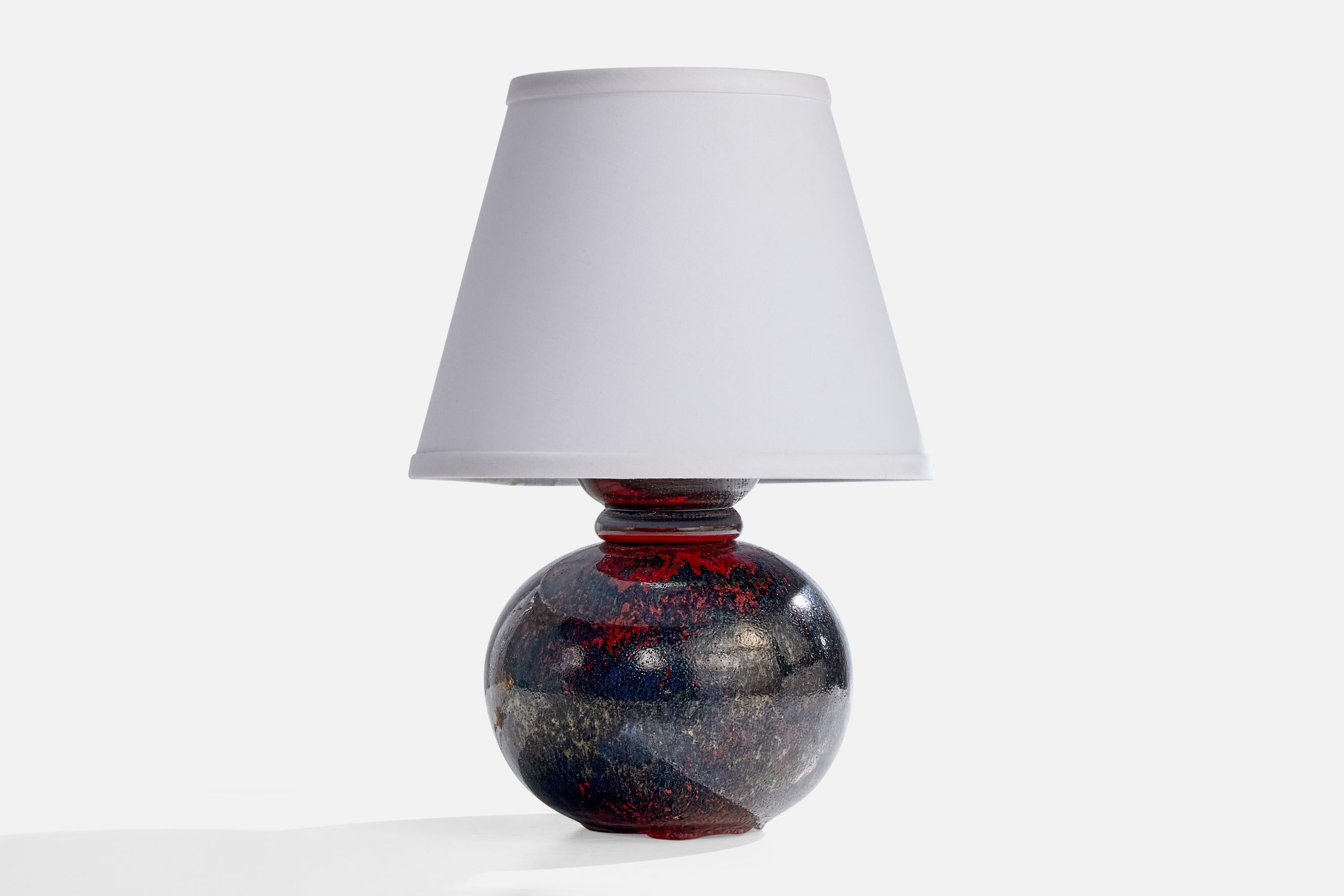 A blue and red-glazed ceramic table lamp designed and produced in Sweden, c. 1940s.

Dimensions of Shade (inches): 6” Top Diameter x 10” Bottom Diameter x 8” Height

Dimensions of Lamp with Shade (inches): 15.15” Height x 10” Diameter

Dimensions of