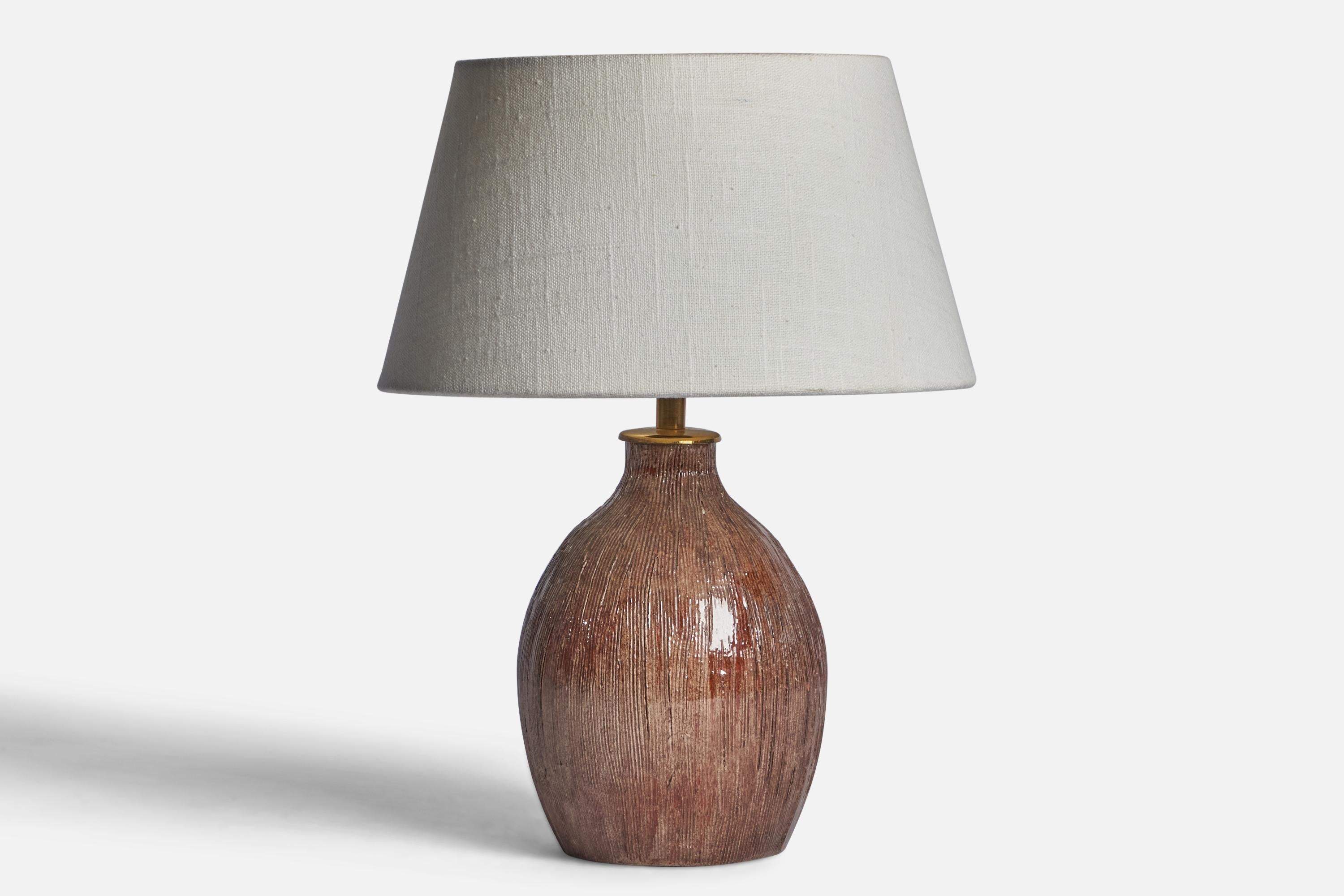 
A brown-glazed incised ceramic and brass table lamp designed and produced in Sweden and dated 1956.
Dimensions of Lamp (inches): 10.45” H x 5.4” Diameter
Dimensions of Shade (inches): 7” Top Diameter x 10” Bottom Diameter x 5.5” H 
Dimensions of