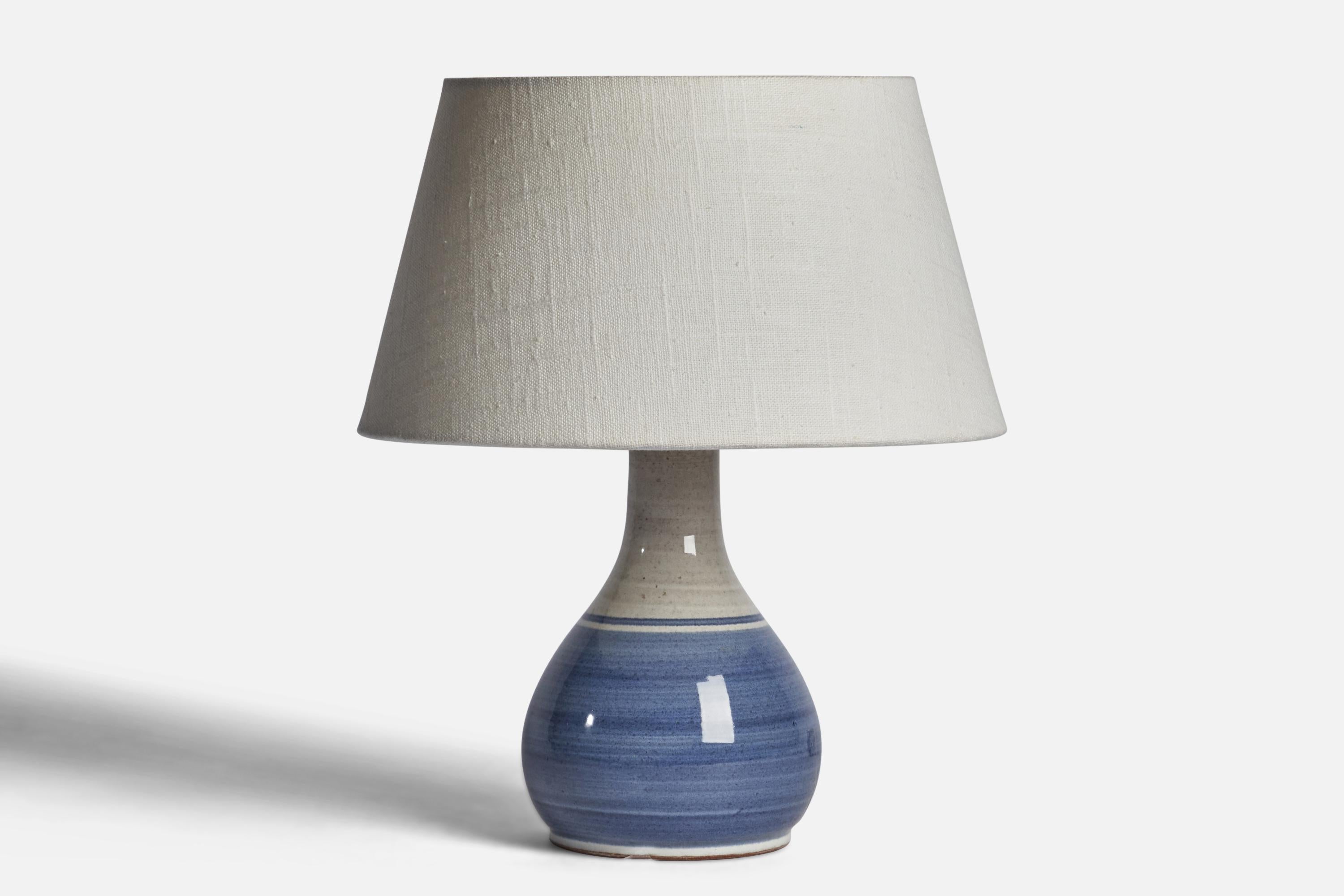 A blue and grey-glazed ceramic table lamp designed and produced in Sweden, c. 1960s.

Dimensions of Lamp (inches): 8.65” H x 4.35” Diameter
Dimensions of Shade (inches): 7” Top Diameter x 10” Bottom Diameter x 5.5” H 
Dimensions of Lamp with Shade