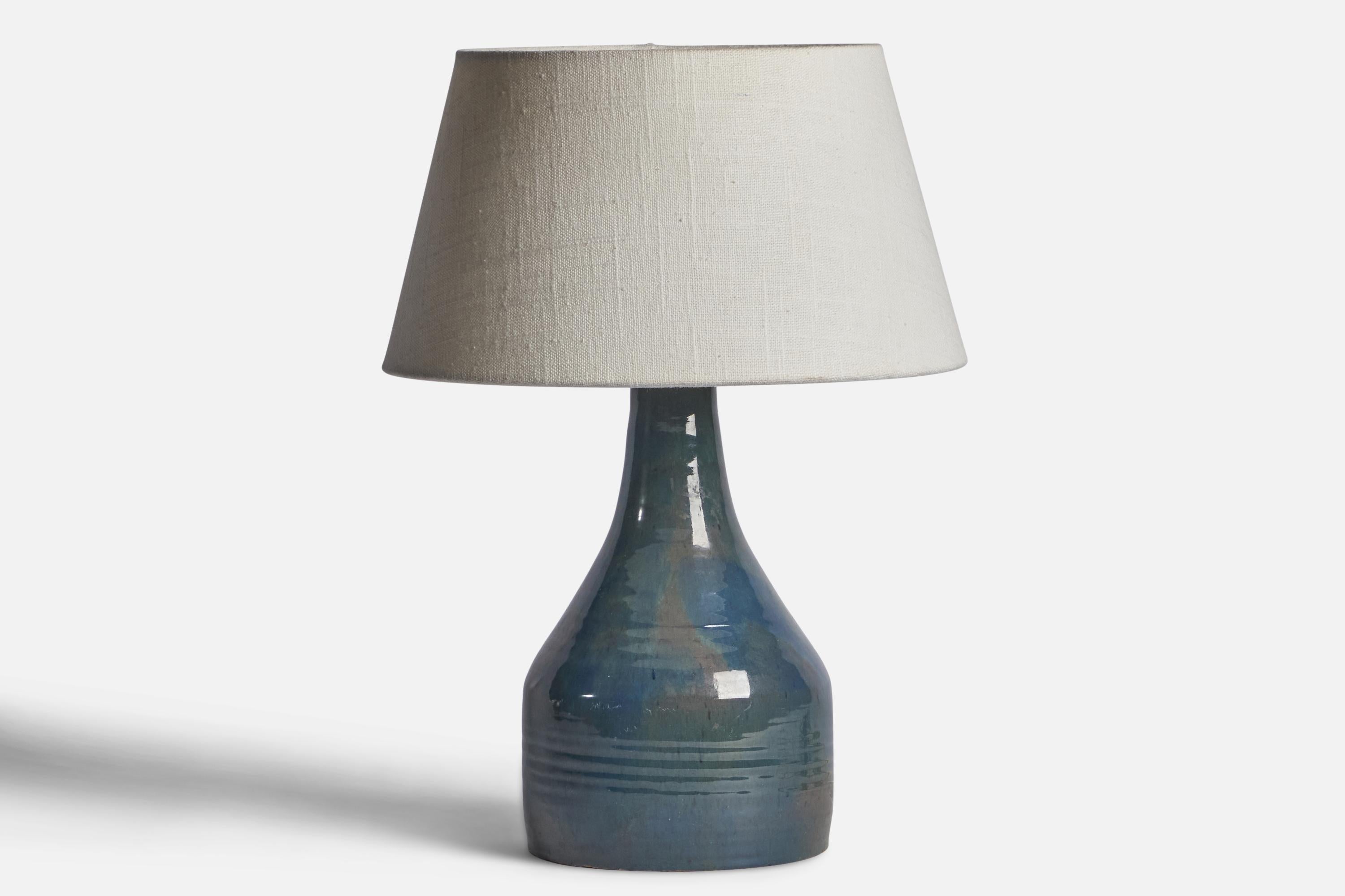 A blue-glazed incised ceramic table lamp designed and produced in Sweden, 1960s.

Dimensions of Lamp (inches): 10.65” H x 5.25” Diameter
Dimensions of Shade (inches): 7” Top Diameter x 10” Bottom Diameter x 5.5” H 
Dimensions of Lamp with Shade