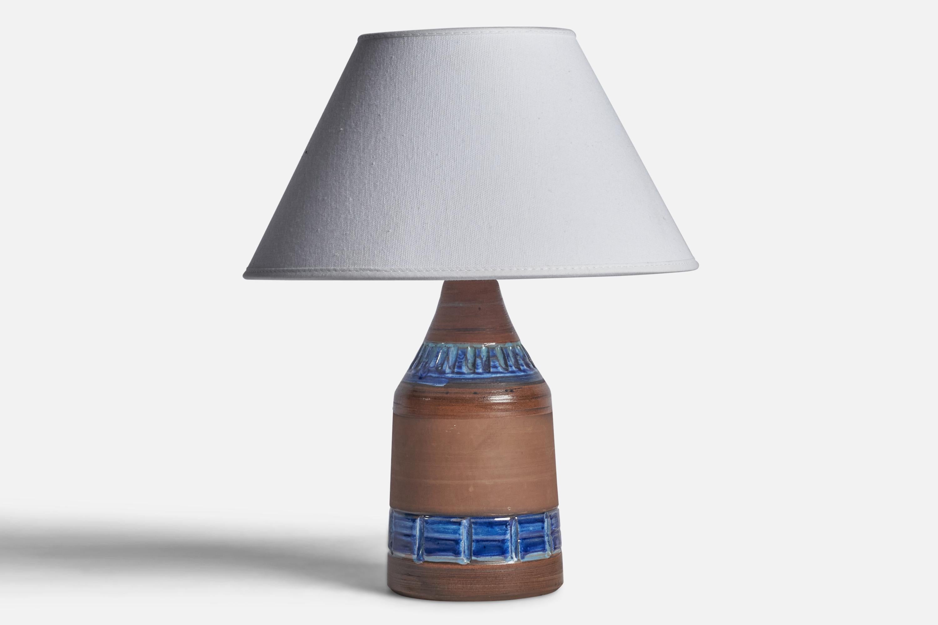 A brown and blue-glazed ceramic table lamp designed and produced in Sweden, c. 1960s.

Dimensions of Lamp (inches): 9.25” H x 3.85” Diameter
Dimensions of Shade (inches): 4.5” Top Diameter x 10” Bottom Diameter x 5.25” H 
Dimensions of Lamp with