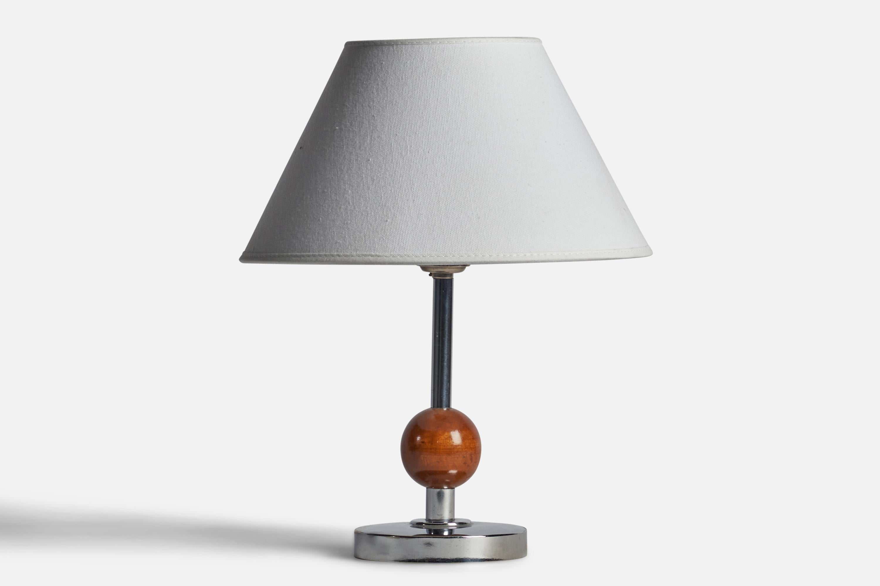 A chrome metal and stained birch table lamp designed and produced in Sweden, 1930s.

Dimensions of Lamp (inches): 8.8” H x 4.25” Diameter 
Dimensions of Shade (inches): 4.5” Top Diameter x 10” Bottom Diameter x 5.25” H 
Dimensions of Lamp with Shade