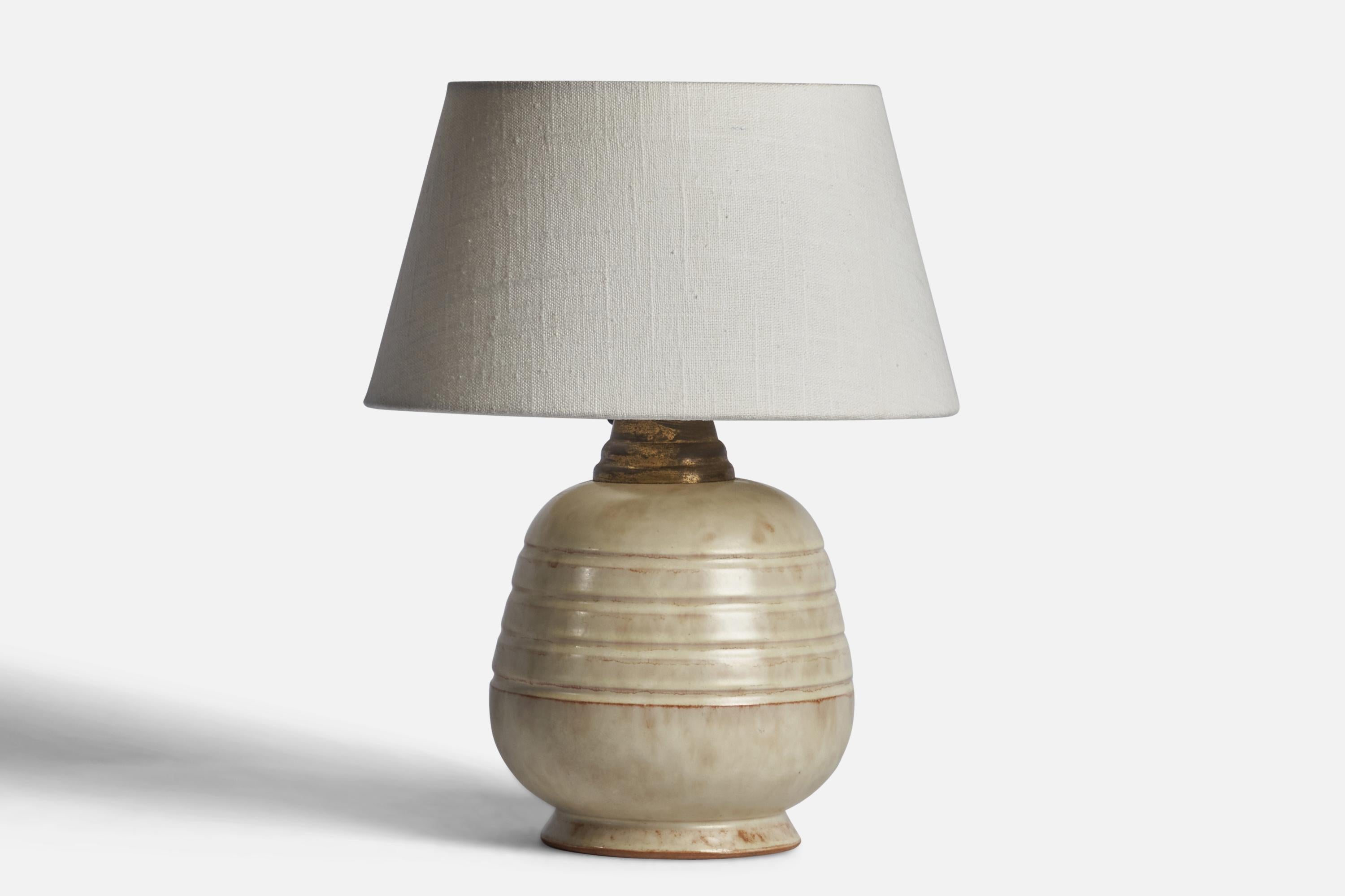 A light grey-glazed earthenware and brass table lamp designed and produced in Sweden, 1930s.

Dimensions of Lamp (inches): 10” H x 6” Diameter
Dimensions of Shade (inches): 7” Top Diameter x 10” Bottom Diameter x 5.5” H 
Dimensions of Lamp with