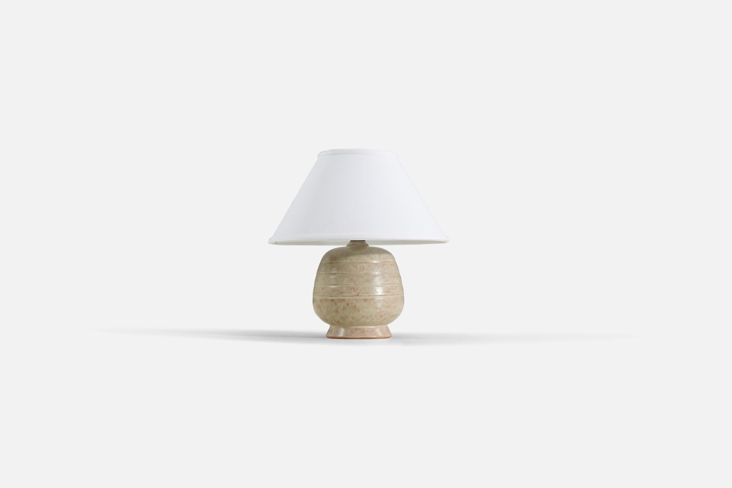 A tan / beige earthenware table lamp produced by a Swedish designer, Sweden, 1960s.

Sold without lampshade. 

Measurements listed are of lamp.
Shade : 5 x 12.25 x 7.25
Lamp with shade : 13.25 x 12.25 x 12.25.
