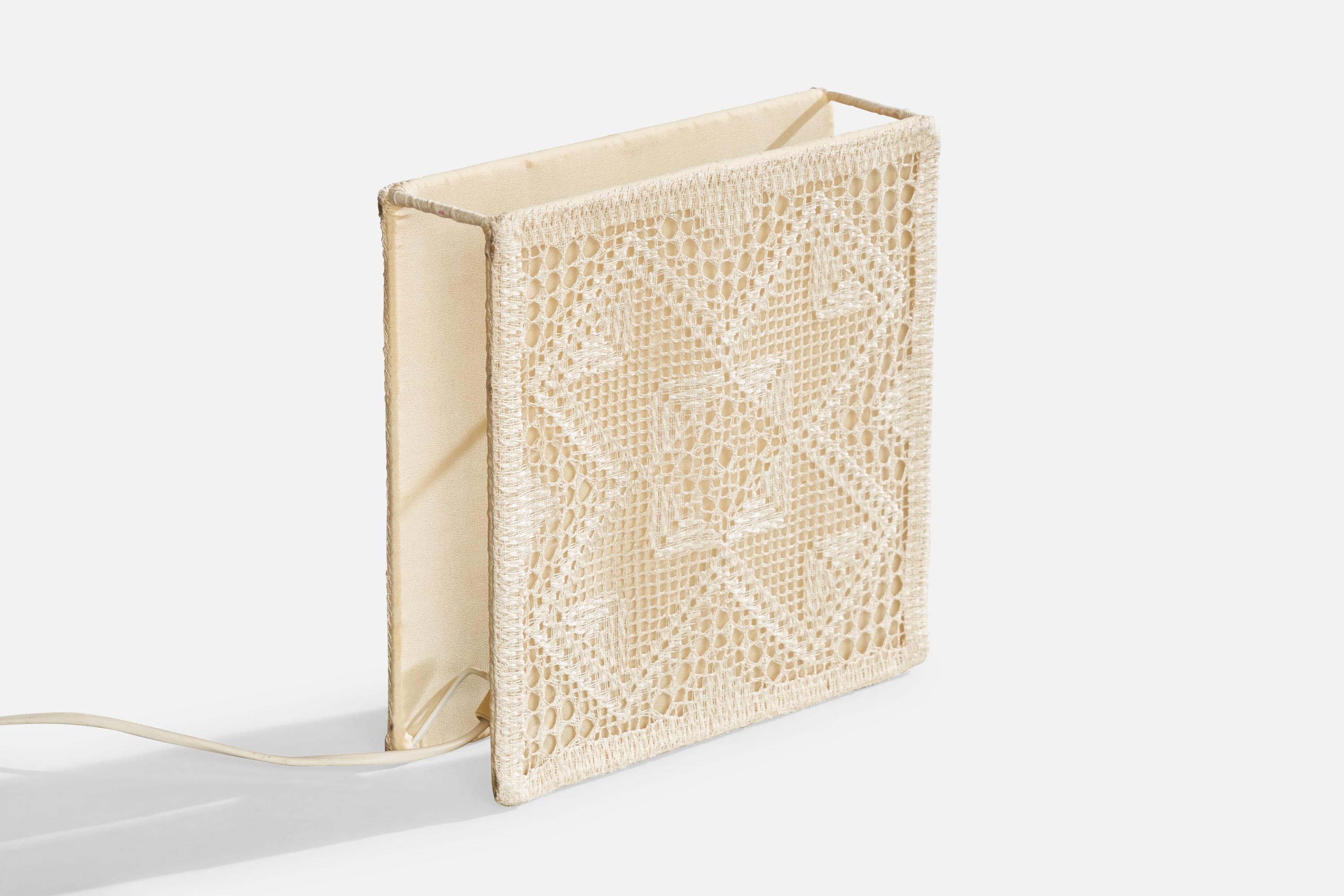 A metal and cream-white embroidery fabric table lamp designed and produced in Sweden, c. 1960s.

Dimensions of Lamp with Shade (inches): 9.2“ H x 9.2” W x 2.6” D

Bulb Specifications: E-14

Number of Sockets (per fixture): 1

All lighting will be