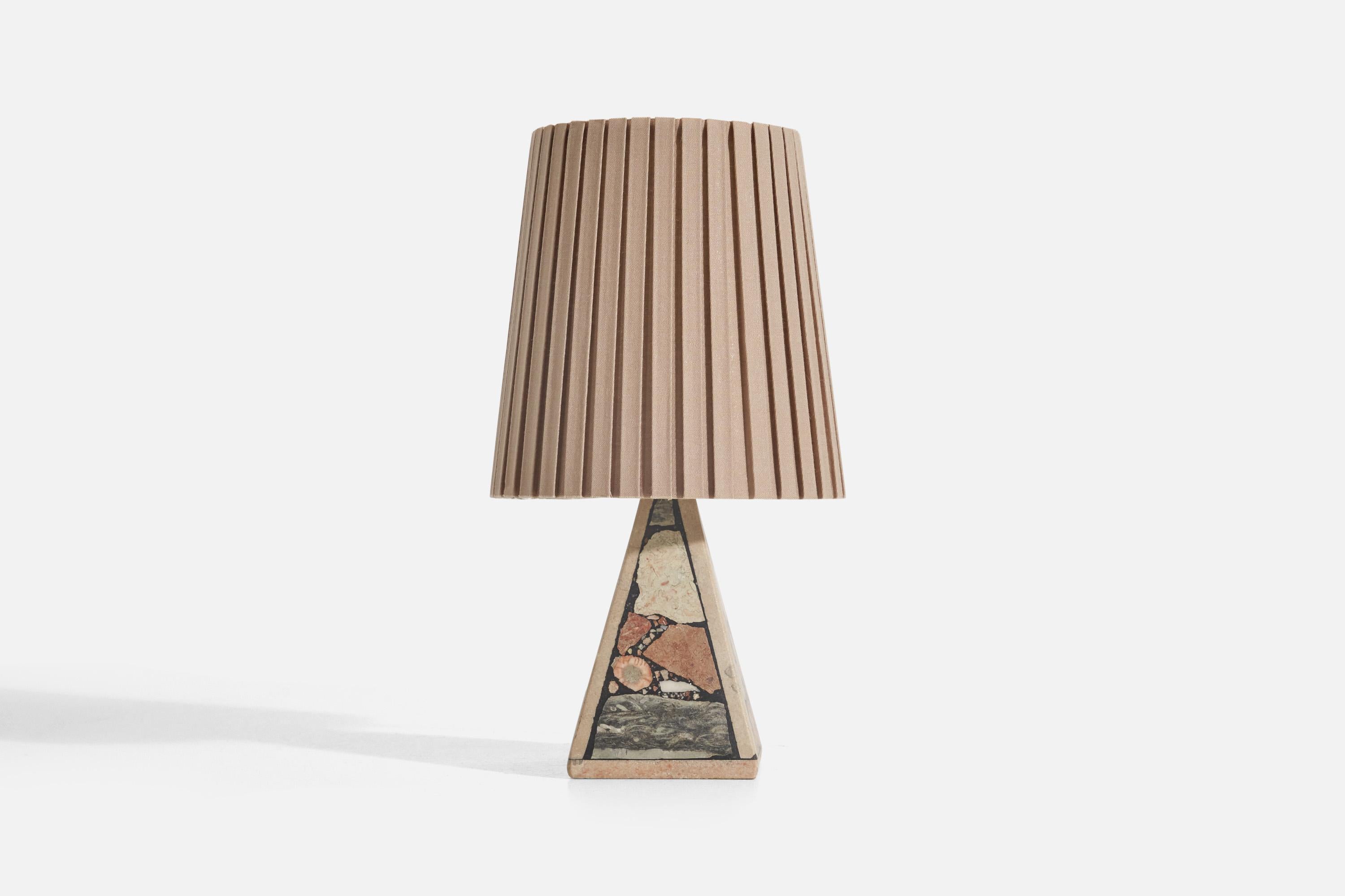 A solid stone table lamp with fossil pieces, Pietra Dura technique, designed and produced in Sweden, c. 1970s.

Sold with fabric Lampshade. 
Stated dimensions refer to the Lamp with the Shade. 

Socket takes E-14 bulb.

There is no maximum