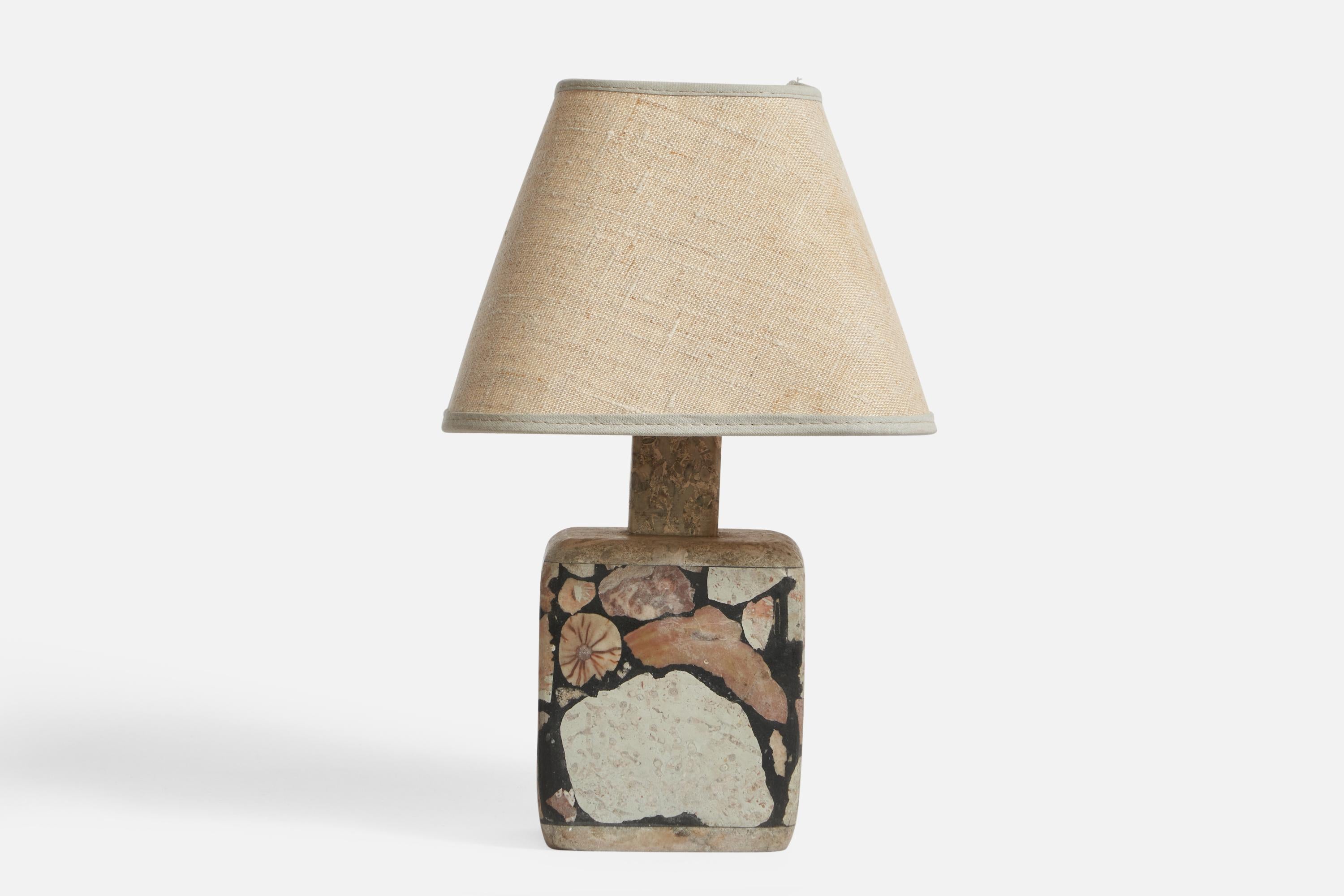 A fossil stone and fabric table lamp designed and produced in Gotland, Sweden, 1970s.

Overall Dimensions (inches): 11.35” H x 7” W x 7” D
Stated dimensions include shade.
Bulb Specifications: E-26 Bulb
Number of Sockets: 1
All lighting will be