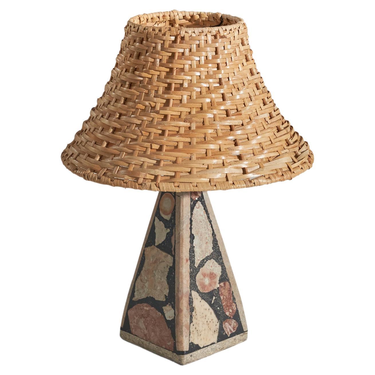 A solid stone table lamp with fossil pieces, Pietra Dura technique, designed and produced in Sweden, c. 1970s.

Sold with rattan lampshade. 
Dimensions of lamp (inches) : 8.75 x 3.48 x 3.36 (Height x Width x Depth)
Dimensions of shade (inches) :