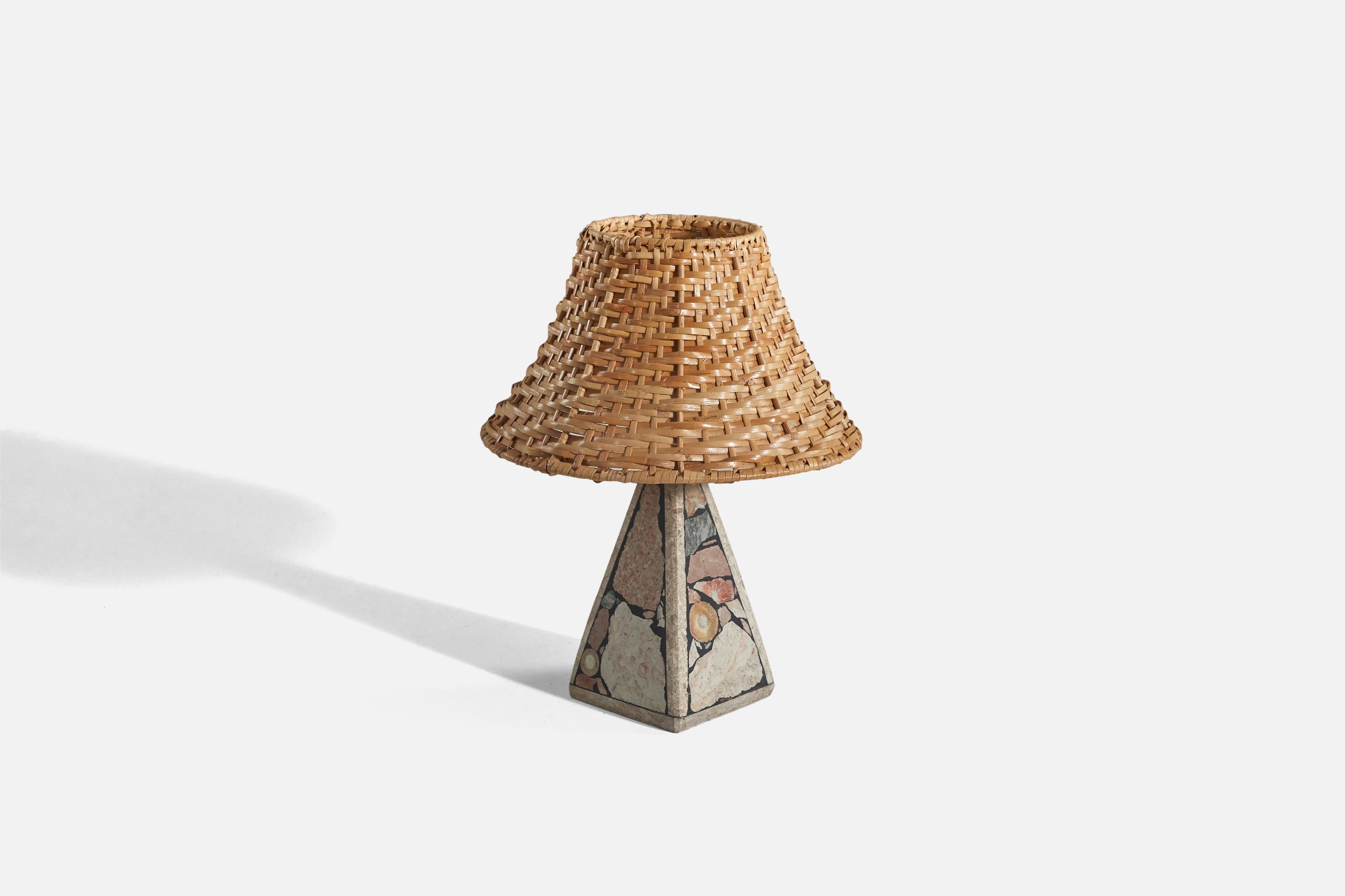 A solid stone table lamp with fossil pieces, Pietra Dura technique, designed and produced in Sweden, c. 1970s.

Sold with rattan lampshade. 
Dimensions of Lamp (inches) : 8.25 x 3.48 x 3.5 (Height x Width x Depth)
Dimensions of Shade (inches) :