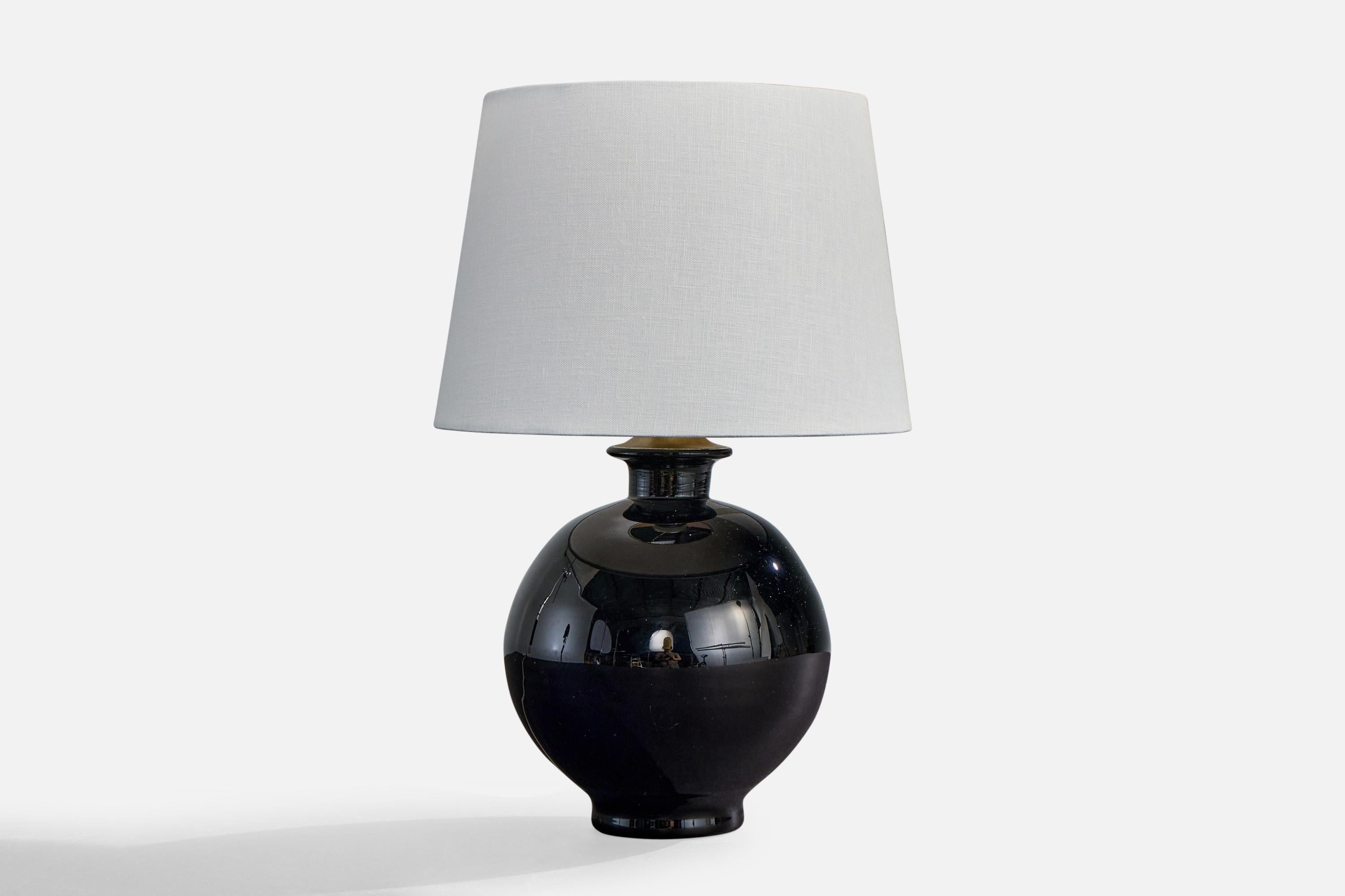 A black-colored glass and brass table lamp designed and produced in Sweden, c. 1940s.

Dimensions of Shade (inches): 8” Top Diameter x 10” Bottom Diameter x 7” Height

Dimensions of Lamp with Shade (inches): 15.5” Height x 10” Diameter

Overall