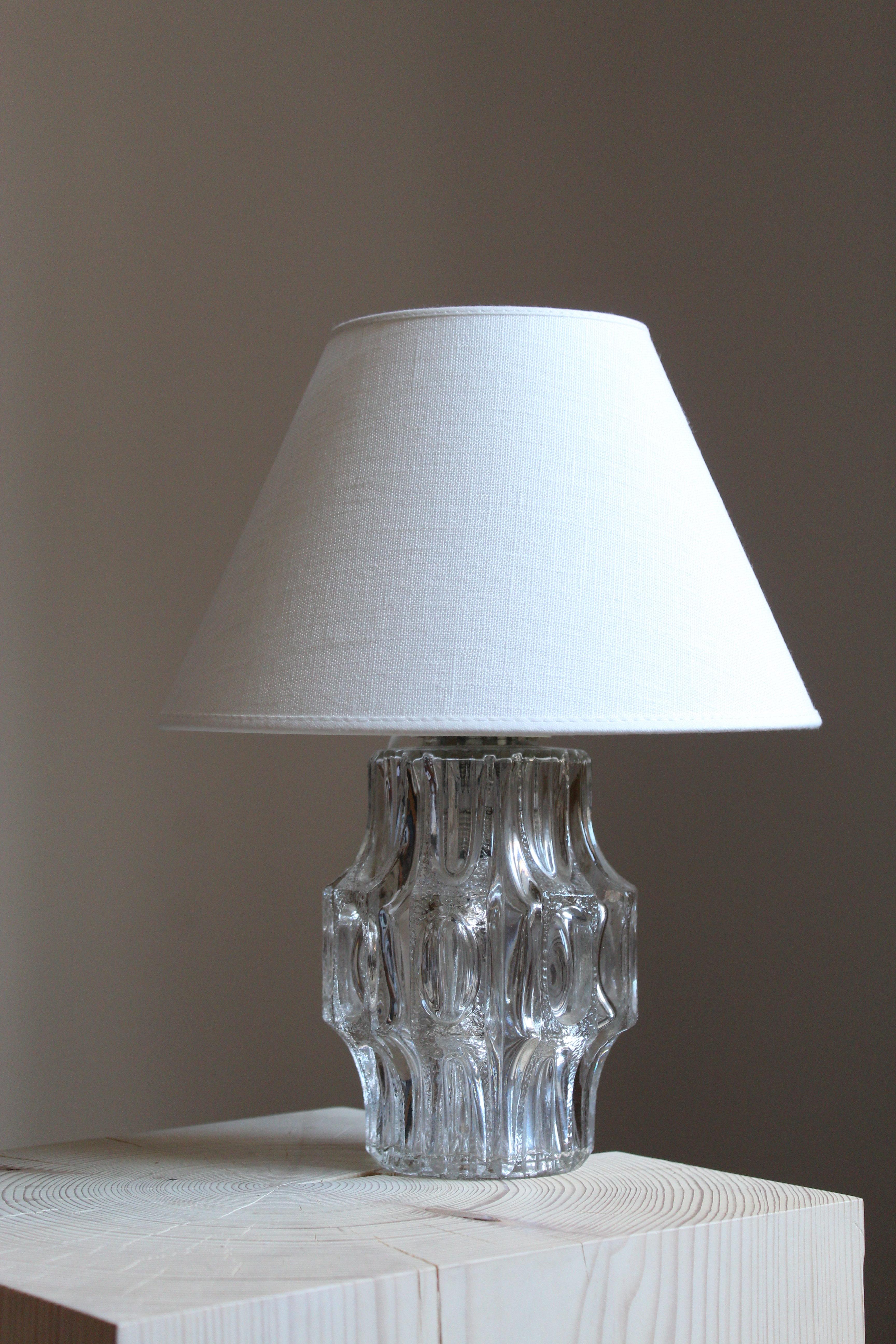 A table lamp. Base in glass. Finely ornamented glass. Sold without lampshade.

Other designers of the period include Paavo Tynell, Lisa Johansson-Pape, Hans Bergström.

 