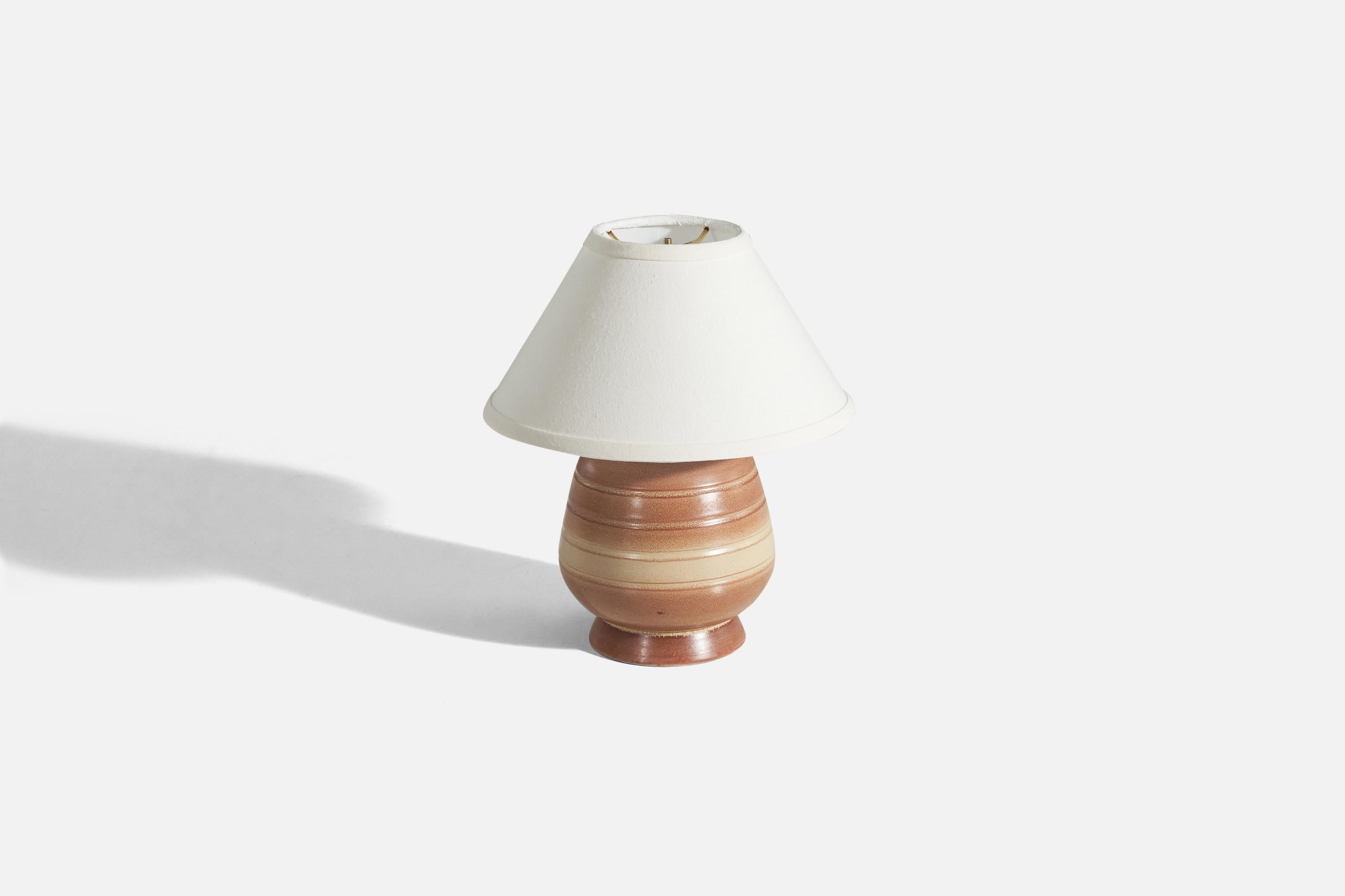A glazed earthenware table lamp produced in Sweden c. 1960s.

Sold without lampshade. 
Dimensions of lamp (inches) : 9.43 x 6.31 x 6.31 (Height x Width x Depth)
Dimensions of shade (inches) : 4.25 x 10.25 x 6 (Top Diameter x Bottom Diameter x