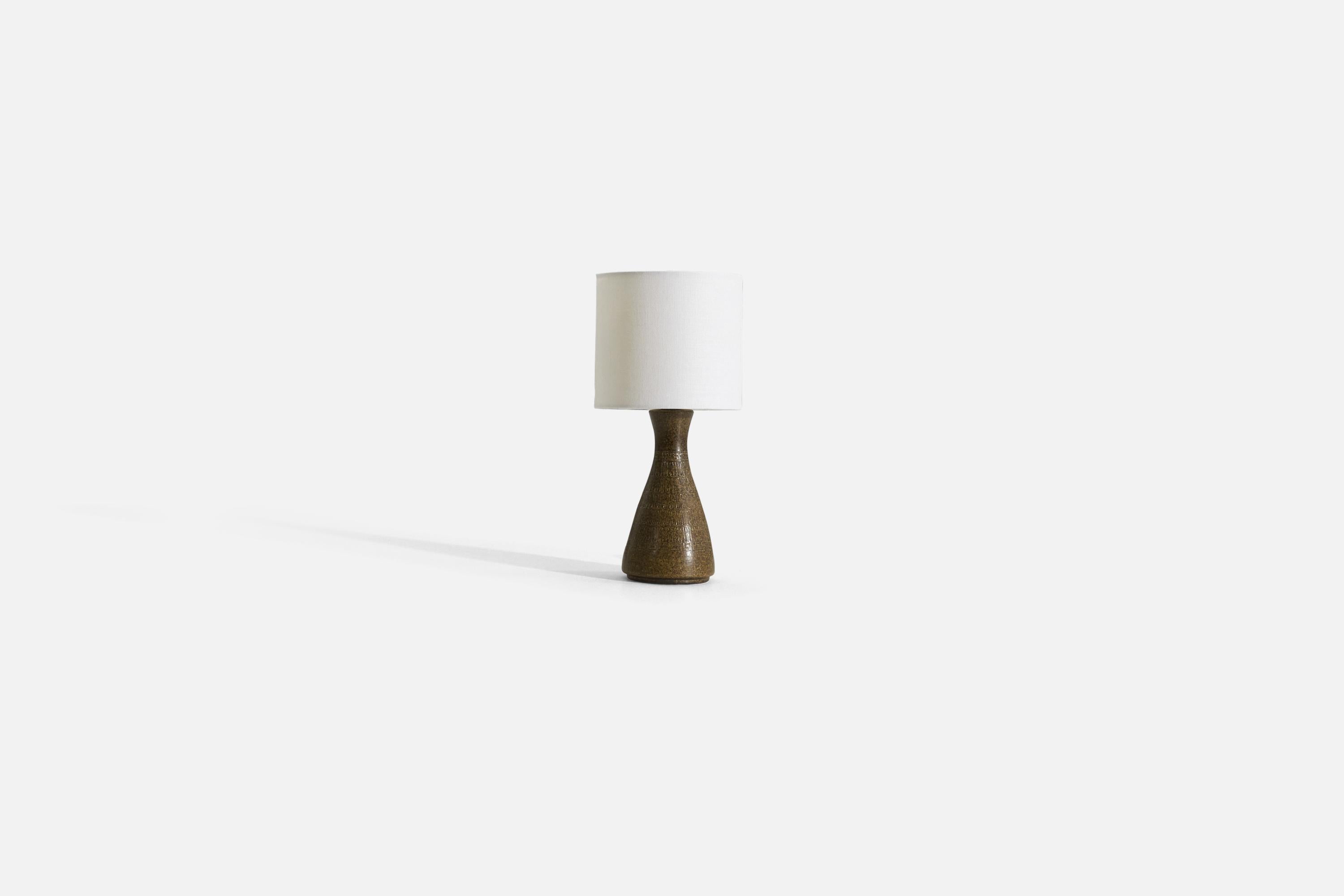 A brown glazed and incised earthenware table lamp produced by a Swedish designer, Sweden, 1960s. 

Sold without lampshade. 

Measurements listed are of lamp.
Shade : 6 x 6 x 5.5
Lamp with shade : 12.5 x 6 x 6.