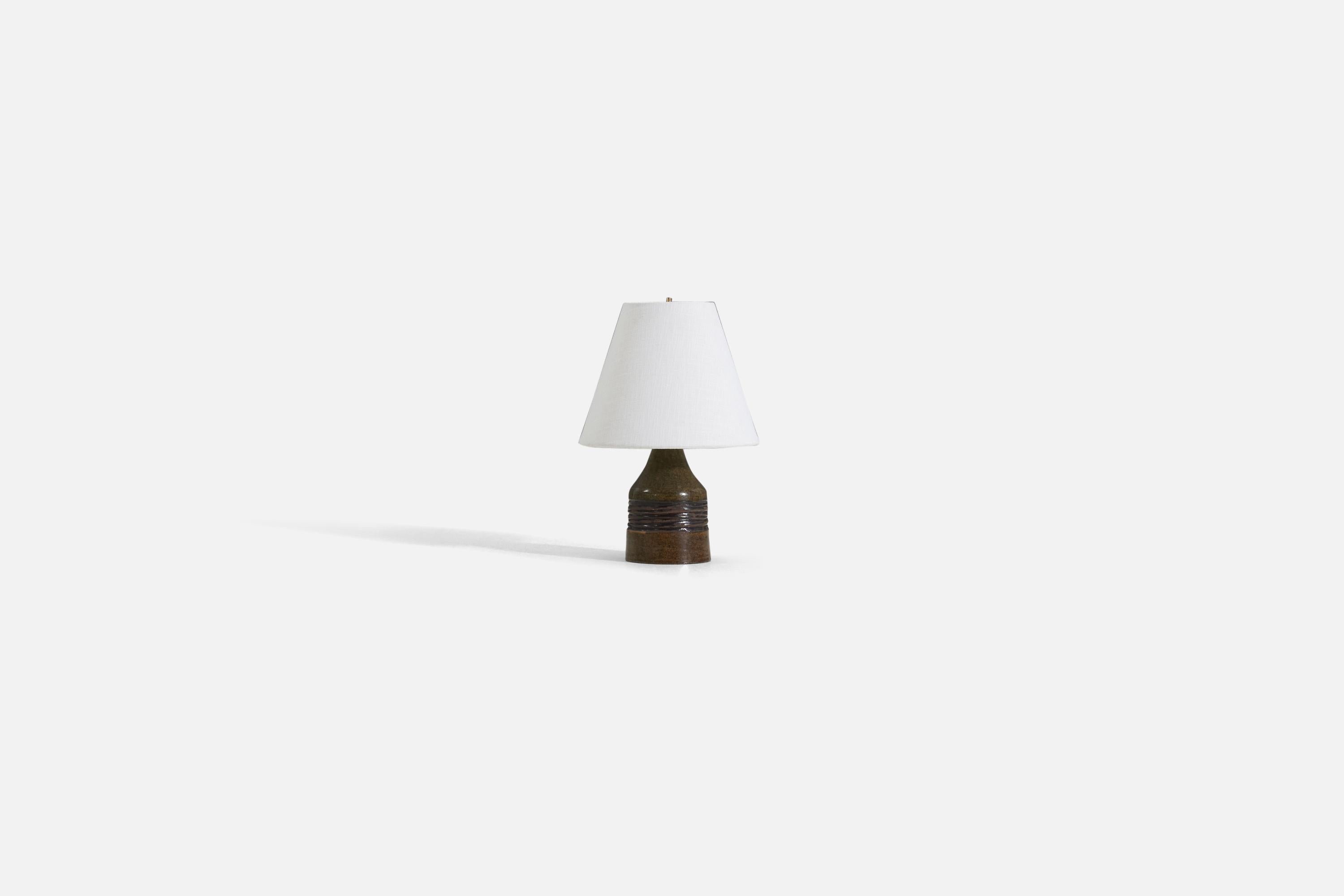 A glazed stoneware table lamp, produced in Sweden, 1960s.

Measurements listed are of lamp. Sold without lampshade.

For reference:

Dimensions of Shade : 4 x 8 x 6.5 
Dimension of Lamp with shade : 11.5 x 8 x 8.