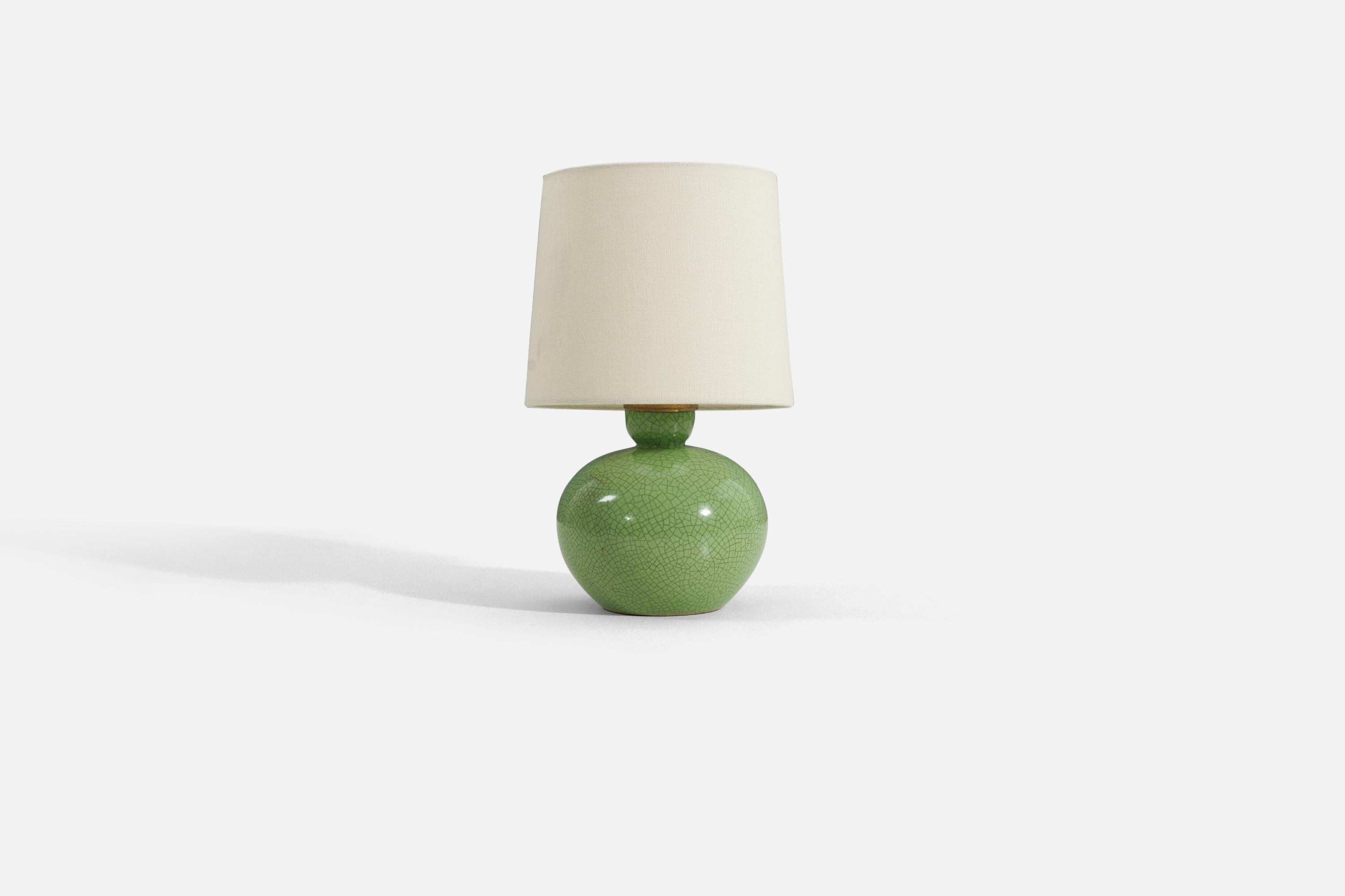A green crackle-glazed earthenware table lamp designed and produced in Sweden, 1940s.

Sold without lampshade. Measurements listed are of lamp only. 

For reference. additional dimensions below. 
Shade : 7 x 8 x 7
Lamp with shade : 13.25 x 8 x