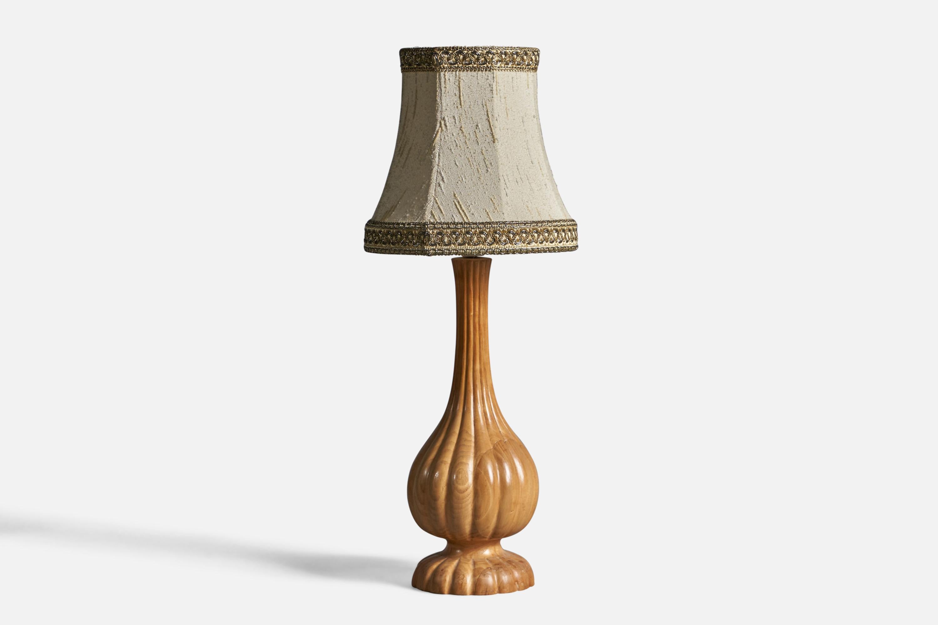 A fluted oak and beige fabric table lamp, designed and produced in Sweden, c. 1960s.

Overall Dimensions (inches): 20.5
