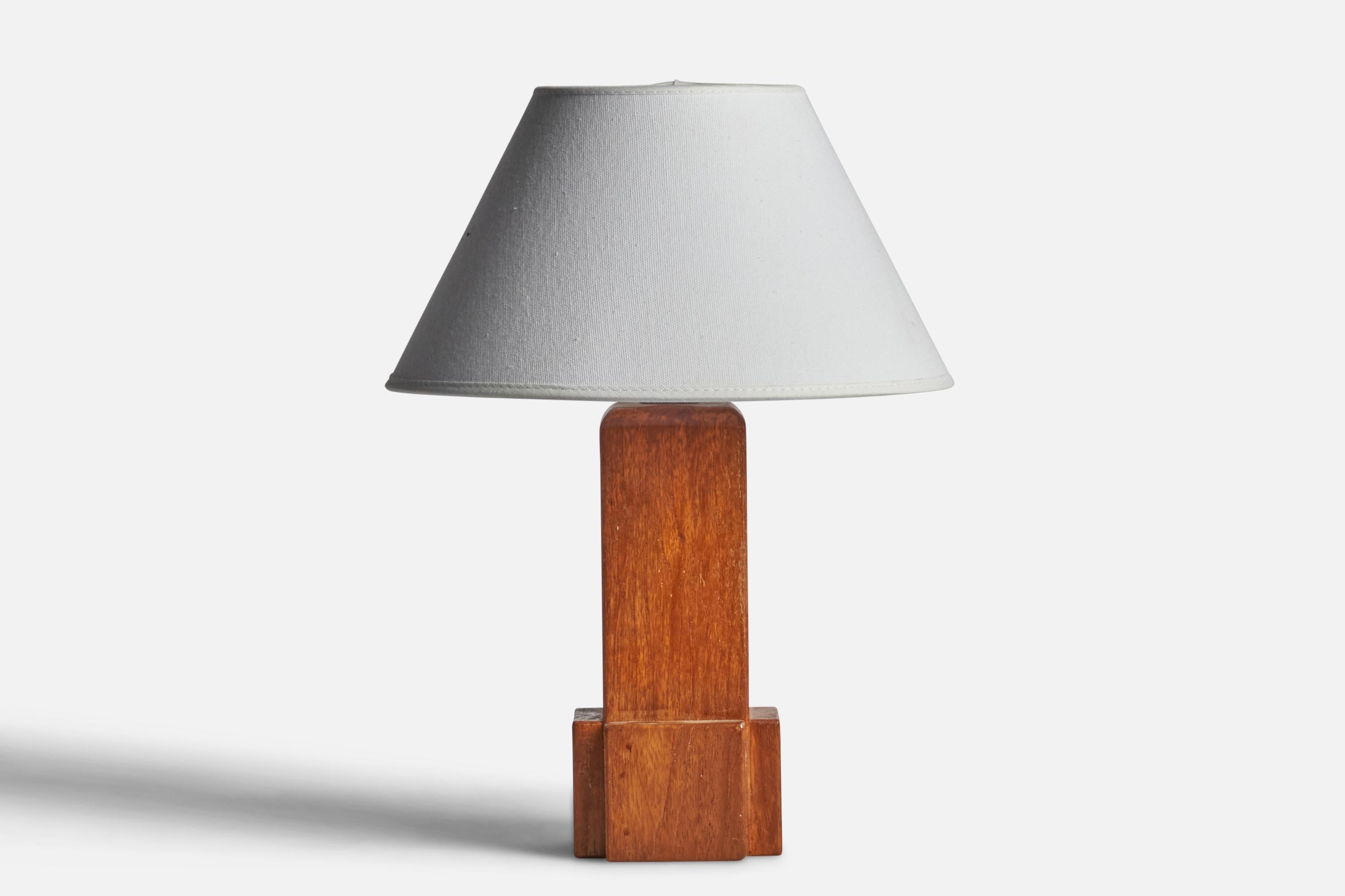 An oak table lamp designed and produced in Sweden, 1950s.

Dimensions of Lamp (inches): 10.25” H x 3.65” Diameter
Dimensions of Shade (inches): 7” Top Diameter x 10” Bottom Diameter x 5.5” H 
Dimensions of Lamp with Shade (inches): 13.25” H x 10”