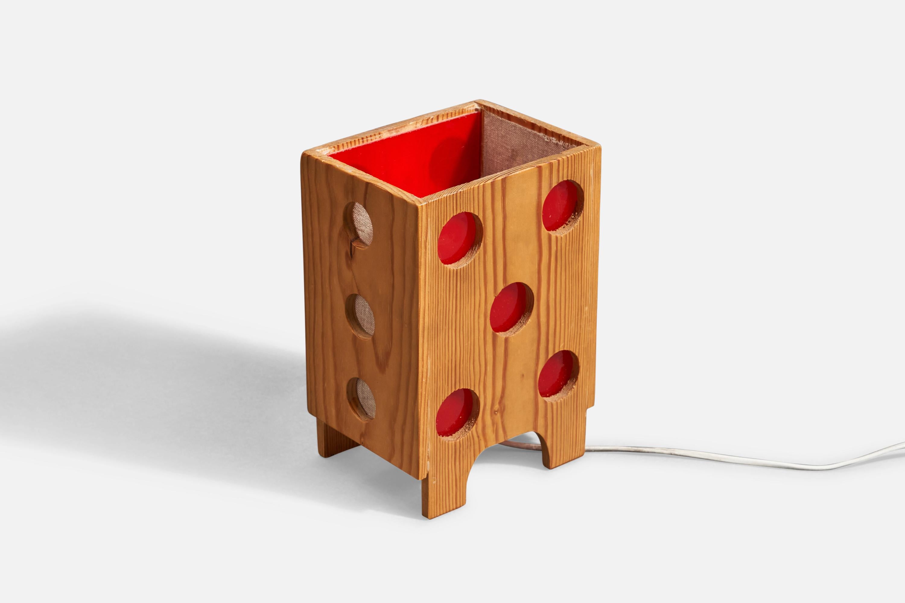 A pine, fabric, and red paper table lamp designed and produced in Sweden, 1970s.

Socket takes standard E-26 medium base bulb.

There is no maximum wattage stated on the fixture.