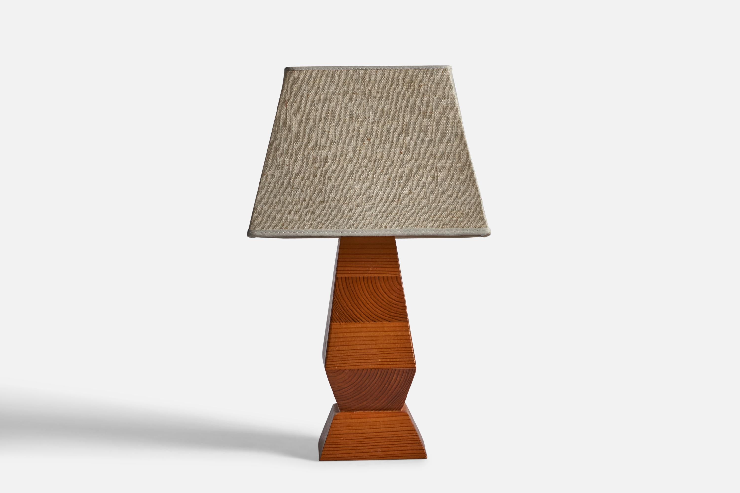 A stack-laminated pine and fabric table lamp, designed and produced in Sweden, c. 1970s.

Overall Dimensions: 15