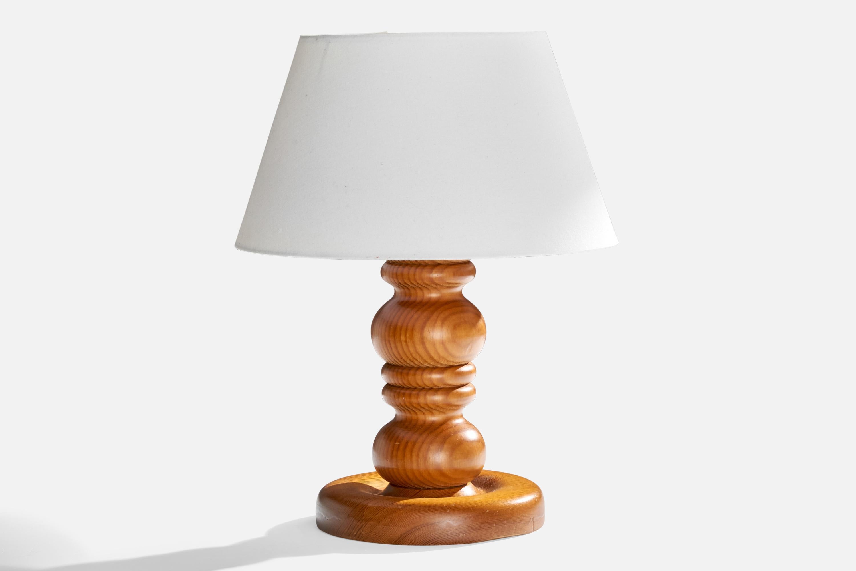 A pine and white fabric table lamp designed and produced in Sweden, c. 1970s.

Dimensions of Lamp (inches): 9.25” H x 7.125” W x 7.125” D

Dimensions of Shade (inches): 7.5” Top Diameter x 11.75” Bottom Diameter x 6.875” H 

Dimensions of Lamp with